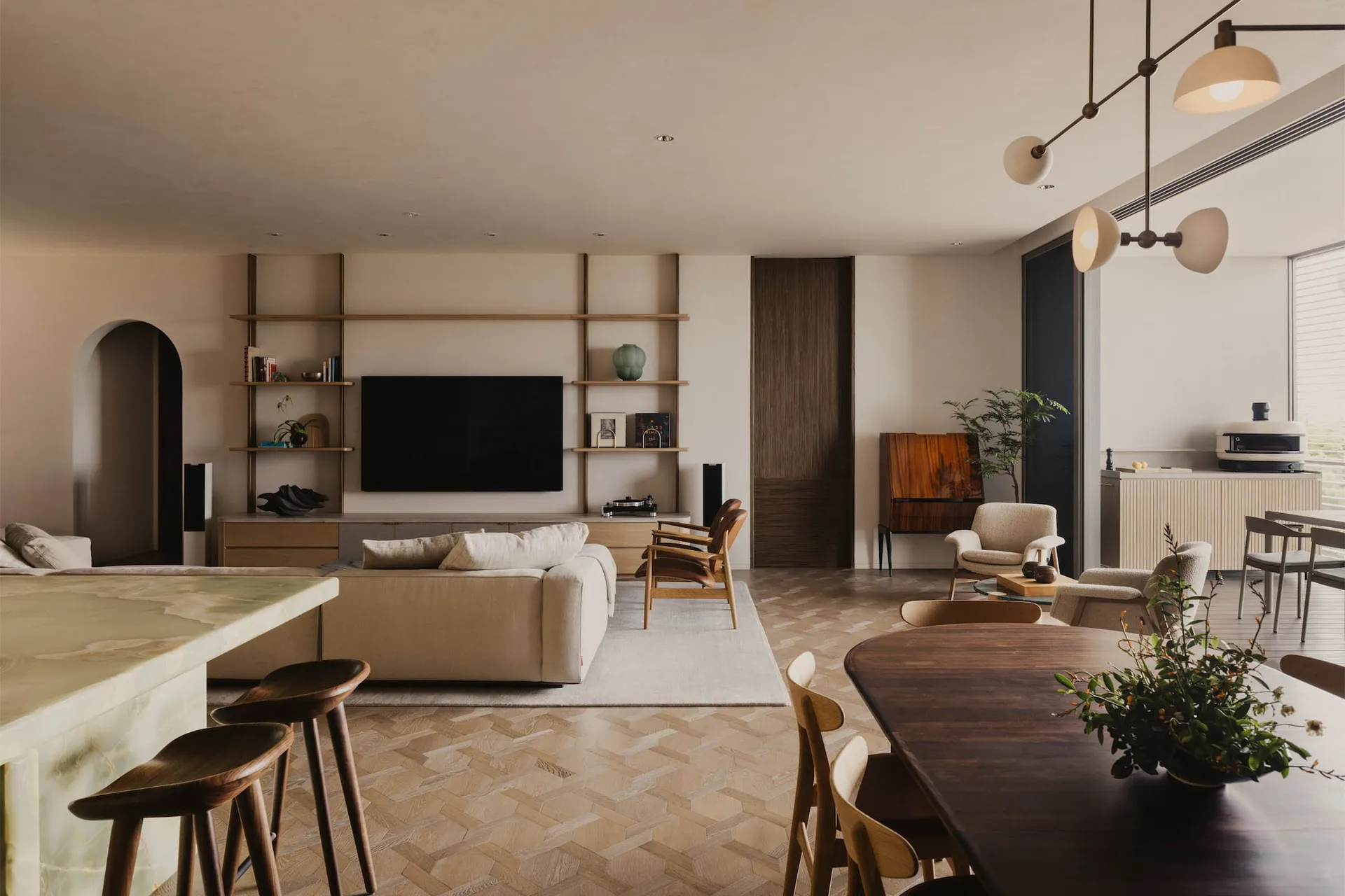 Modern living room featuring wooden flooring and furniture, with a minimalist design aesthetic.