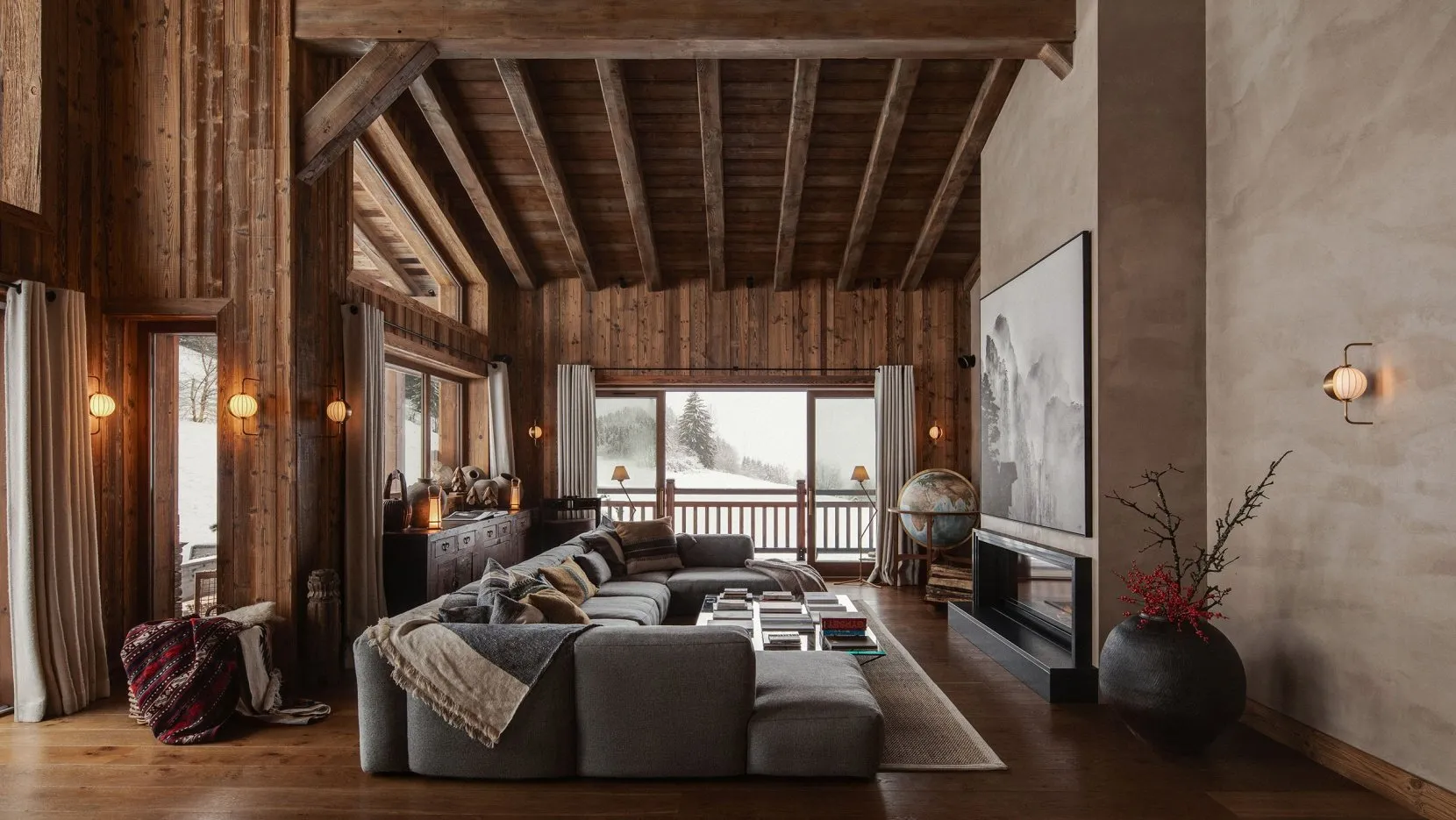 A cozy, rustic living room with wooden furniture and a large sectional sofa.