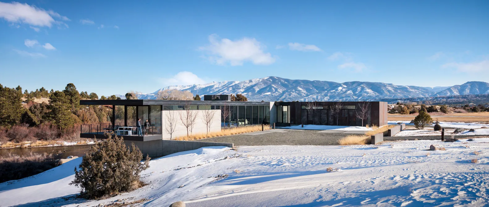 Modern residential home with concrete, glass, and metal exterior materials.
