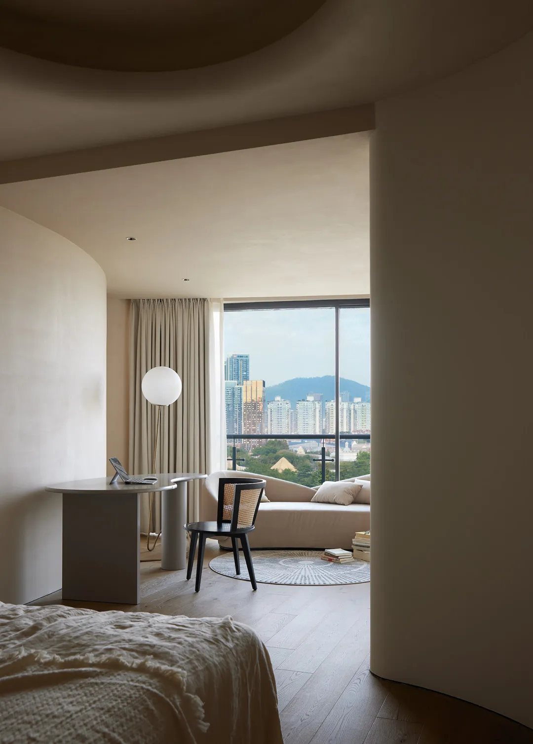 Modern minimalist bedroom featuring concrete walls, wooden furniture, and fabric finishes.