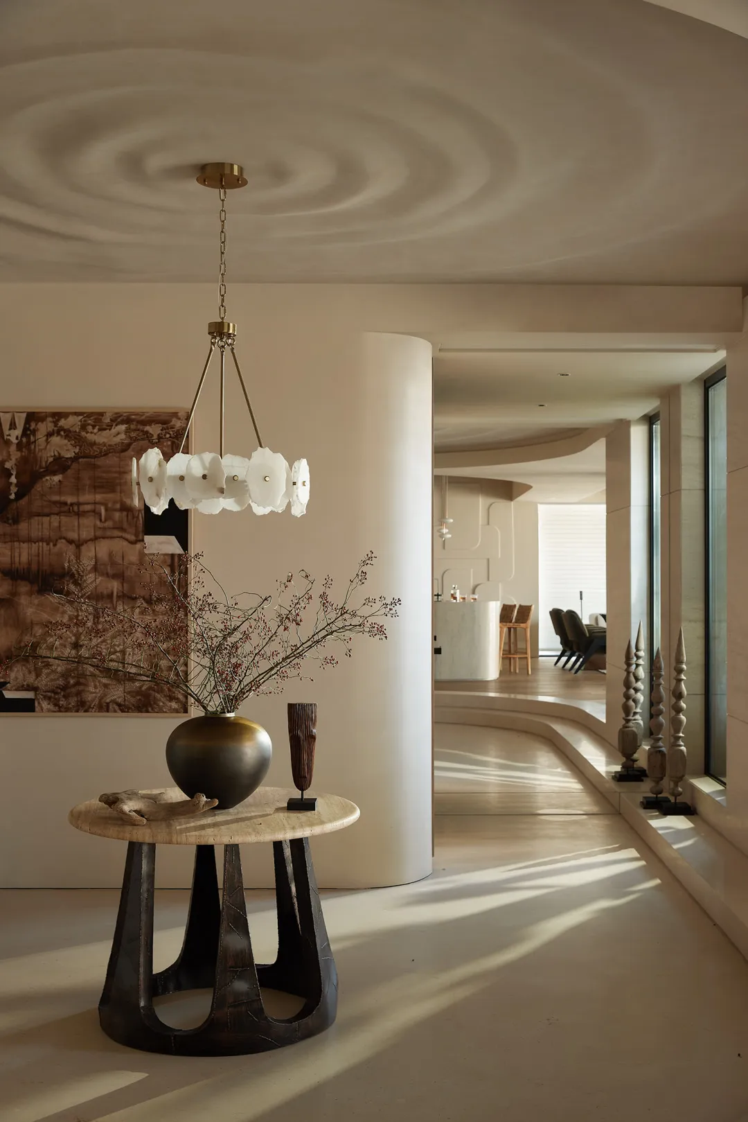An elegant entrance featuring a modern design with marble and concrete materials.