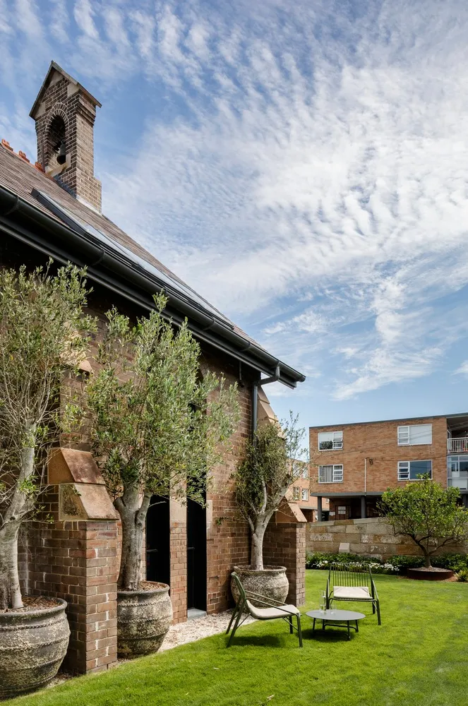 A modern residential exterior with brick, glass, and metal accents.