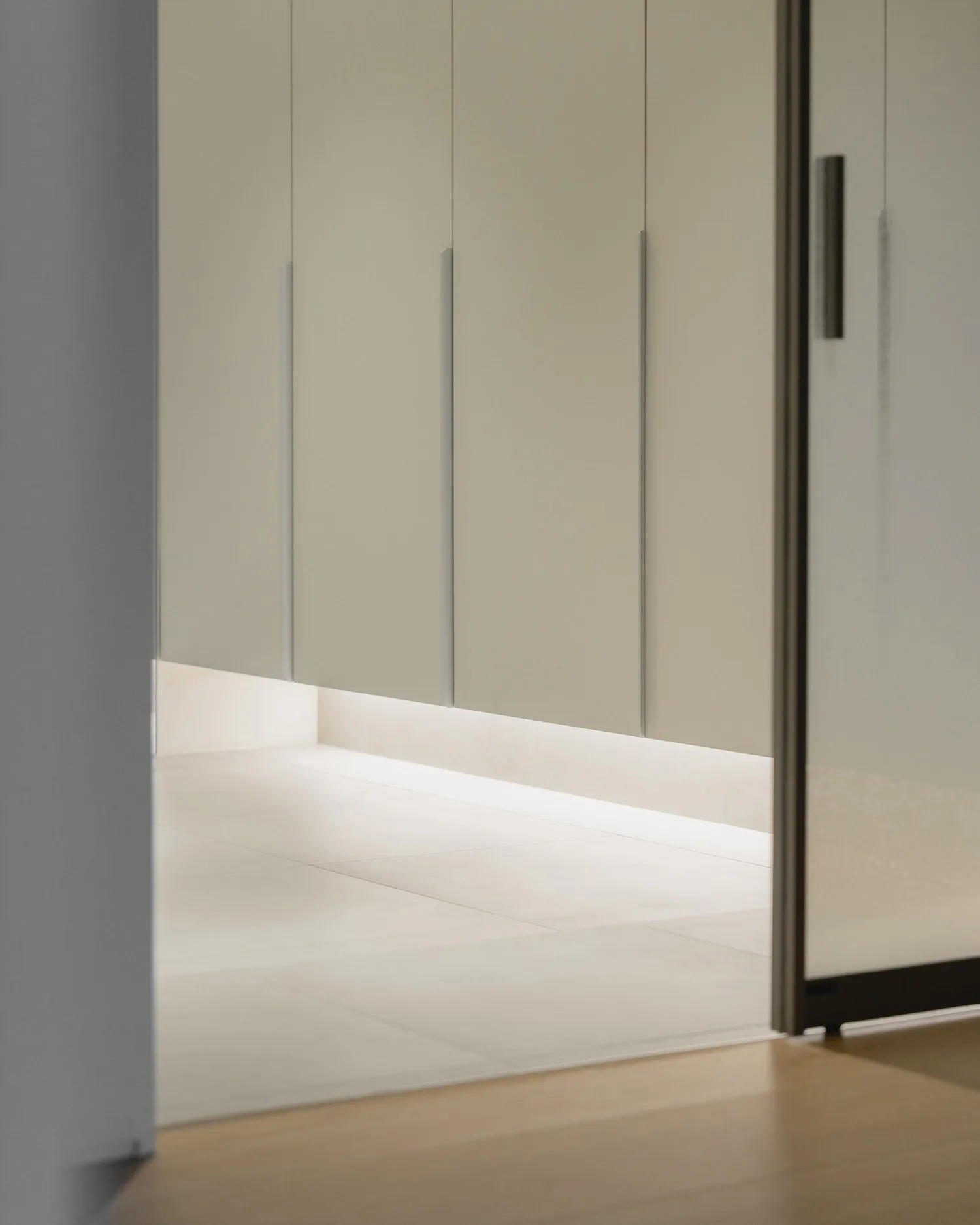 A minimalist bedroom featuring white wall panels and a concrete floor, creating a serene and contemporary atmosphere.