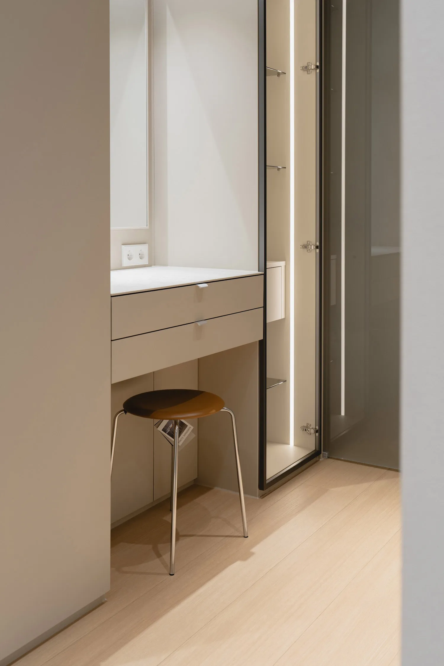 A minimalist bathroom featuring glass panels, modern design, and a sleek, uncluttered atmosphere.