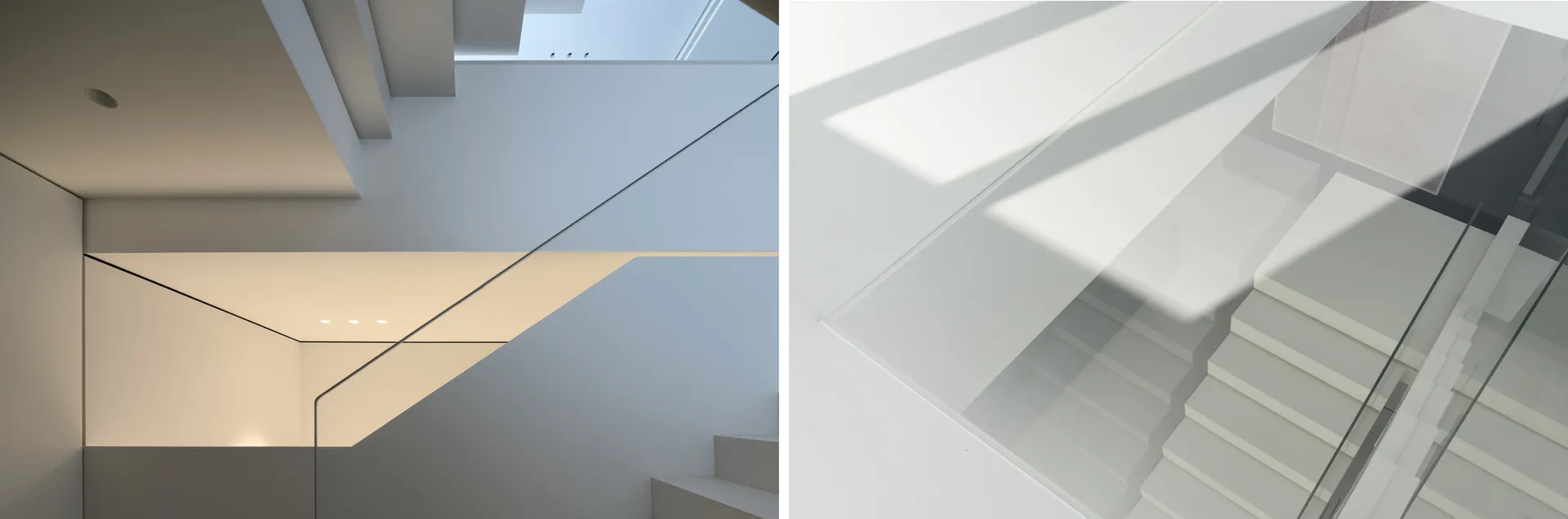 A modern staircase with timber and glass elements. The sunlight casts shadows on the wall, highlighting the sleek, minimalist