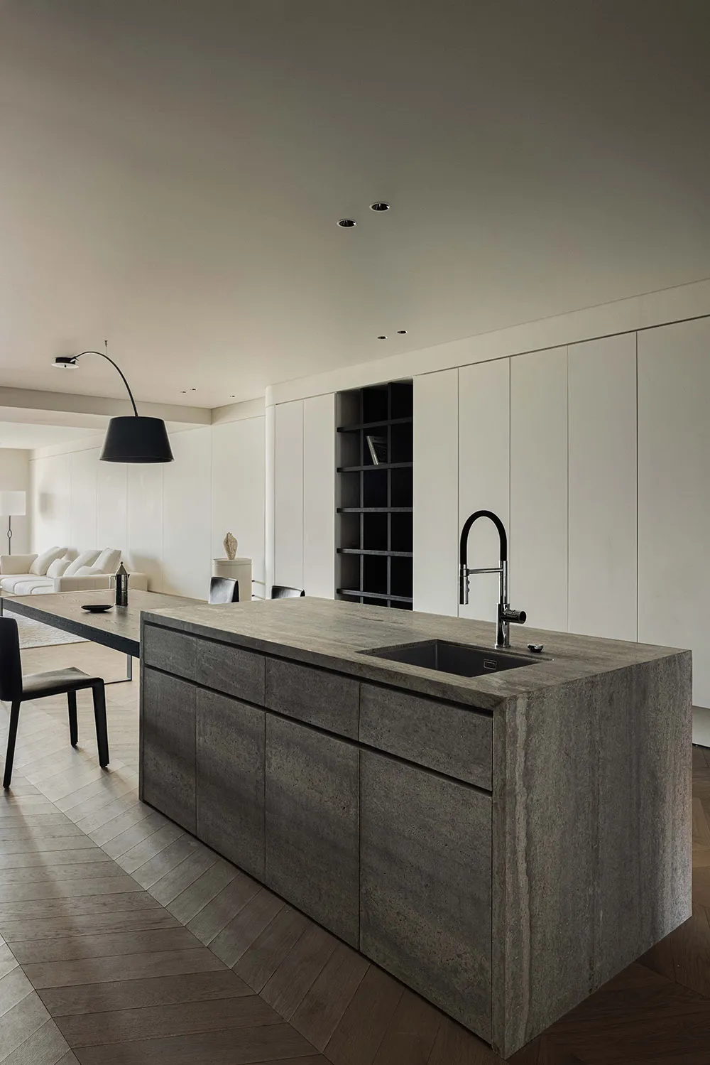 A modern residential kitchen featuring grey concrete cabinets, a sink, and a matching countertop.