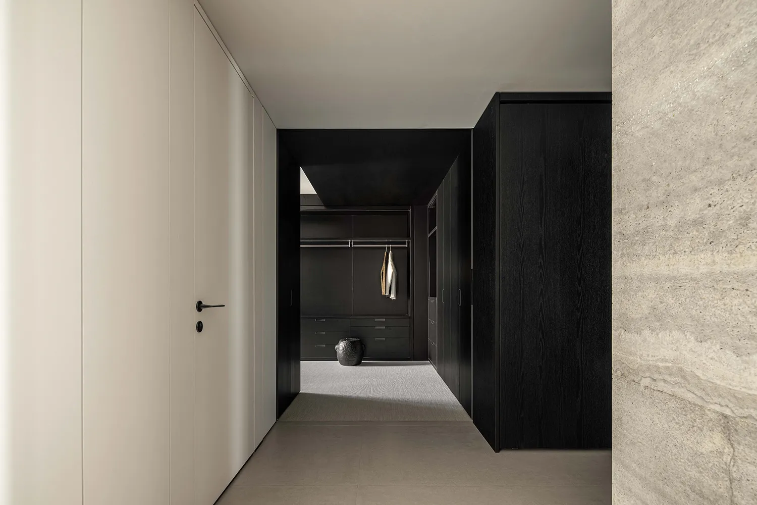 Concrete, steel, and leather interior with clothing realloc.