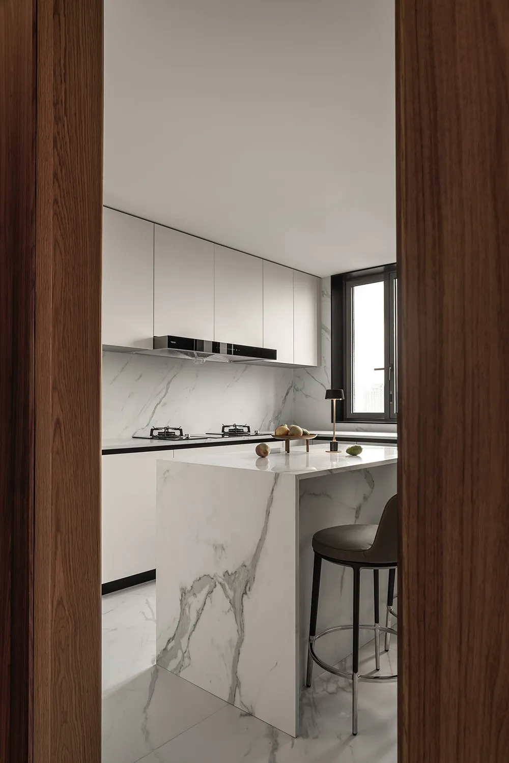Modern minimalist kitchen with marble countertops and minimalist design features.