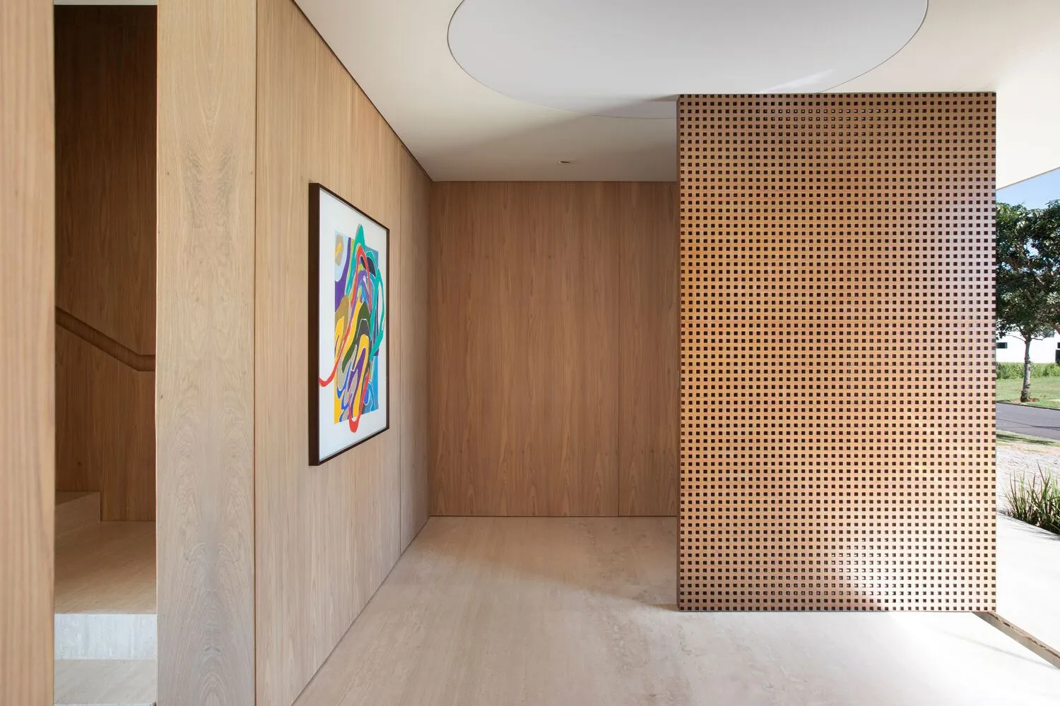 Modern interior with wooden walls, perforated panel, and concrete floor