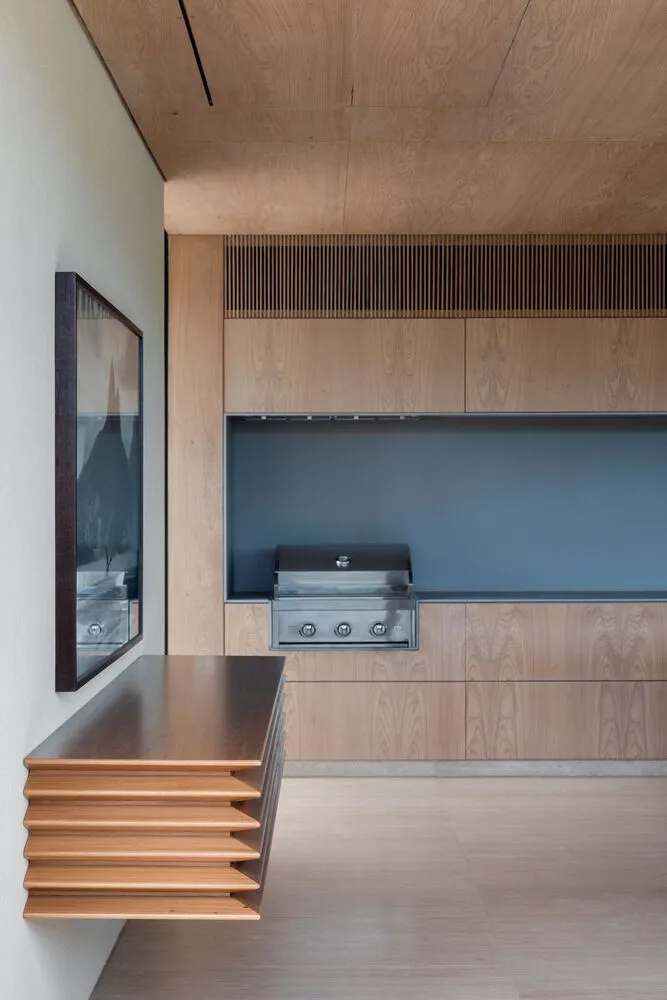 Modern minimalist kitchen with wooden finishes and sleek design.