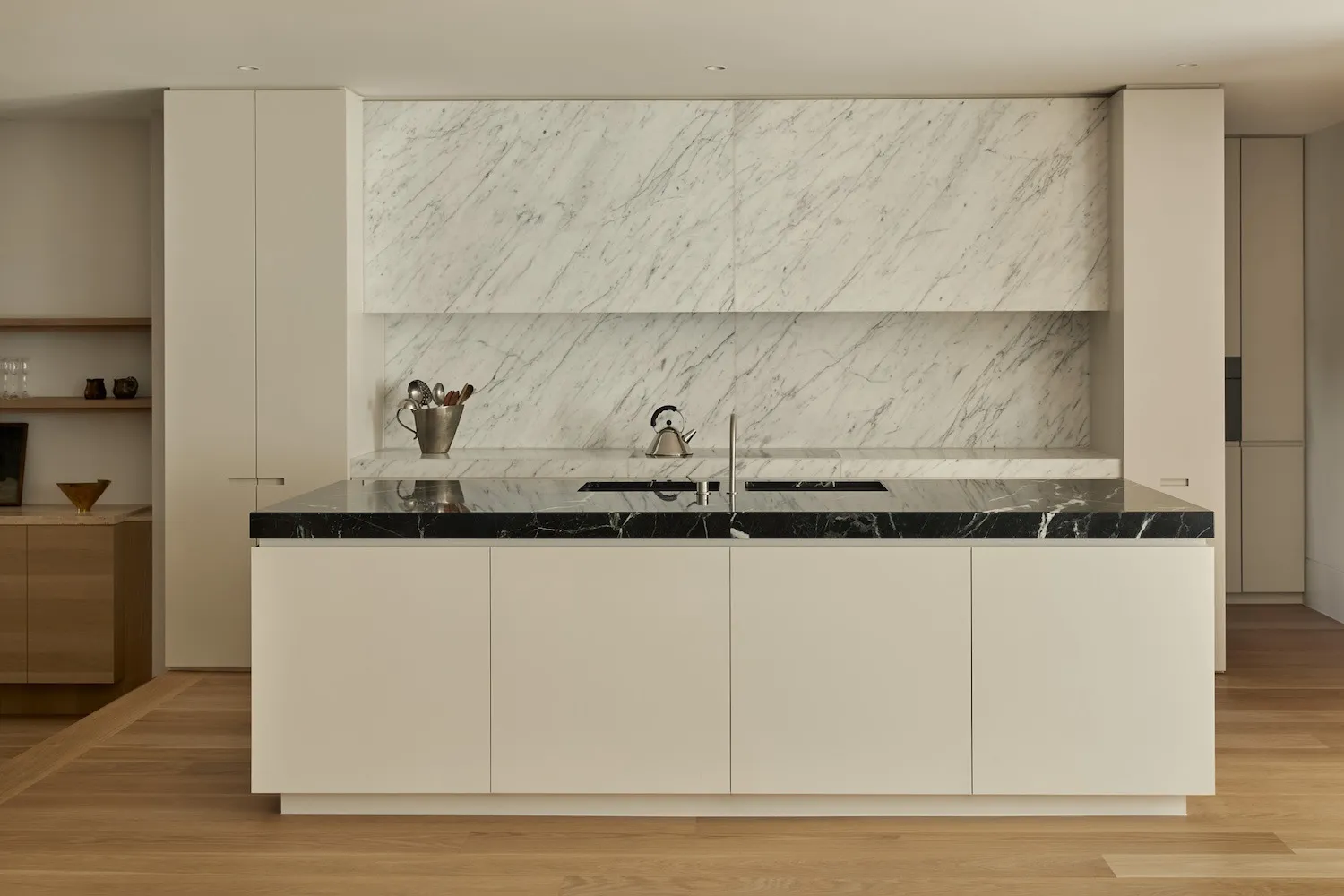 Modern kitchen with marble countertops and backsplash in a residential setting.