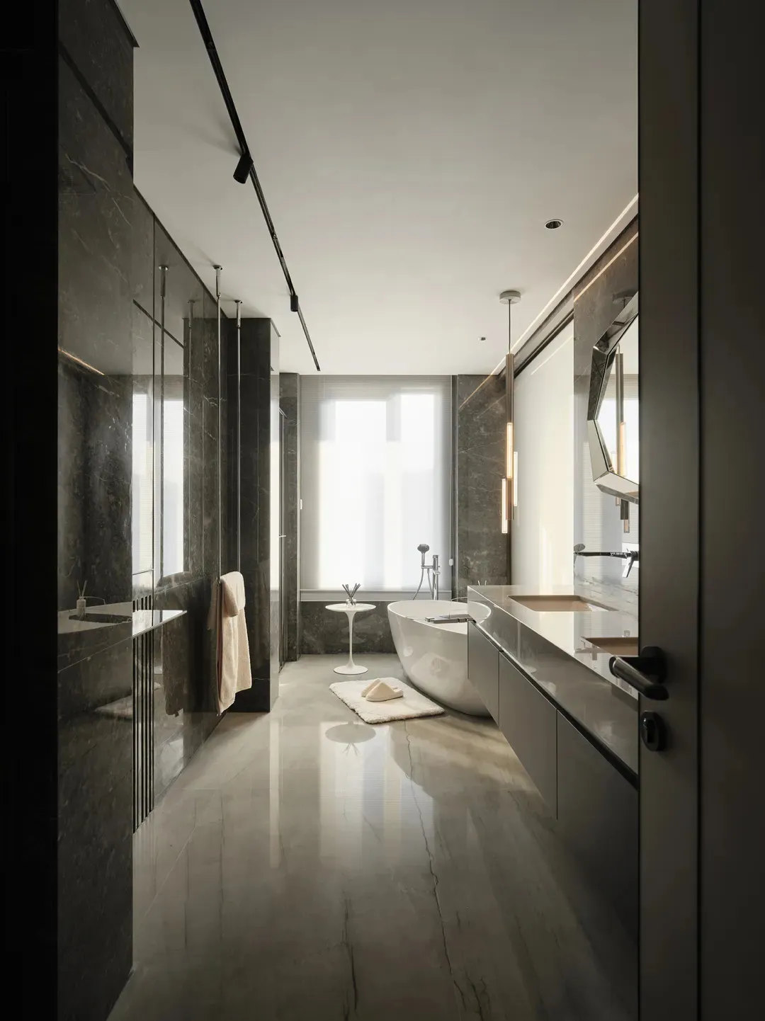 Contemporary bathroom featuring marble tiles and minimalist design elements.