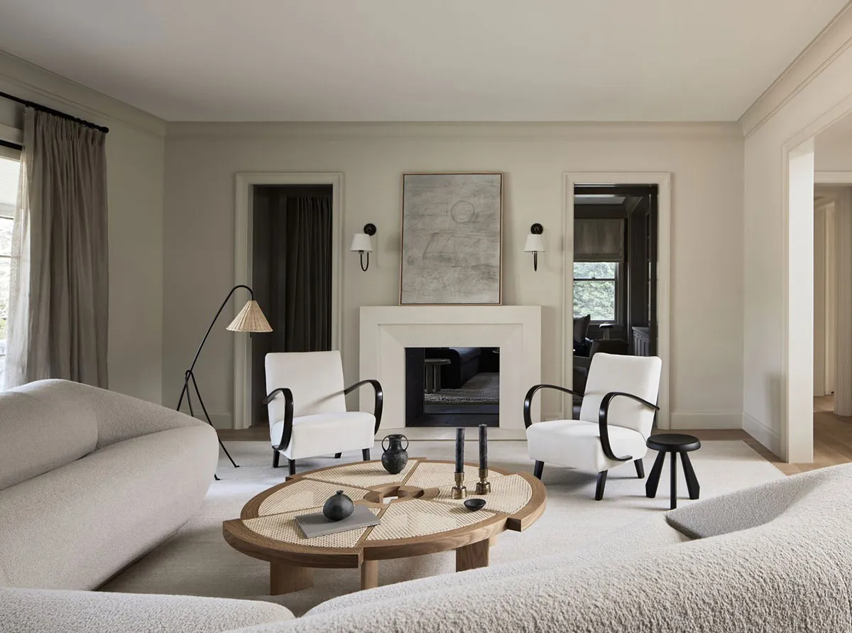 Modern living room featuring neutral-toned furniture and materials, minimalist design, and a cozy ambiance.