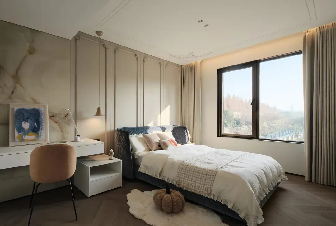 A modern bedroom featuring a large bed, stylish furniture, and a large window with a view of nature.