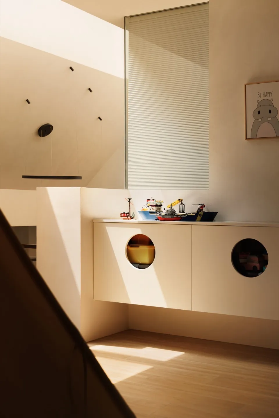 A modern, minimalist children's playroom with wood materials and toys.