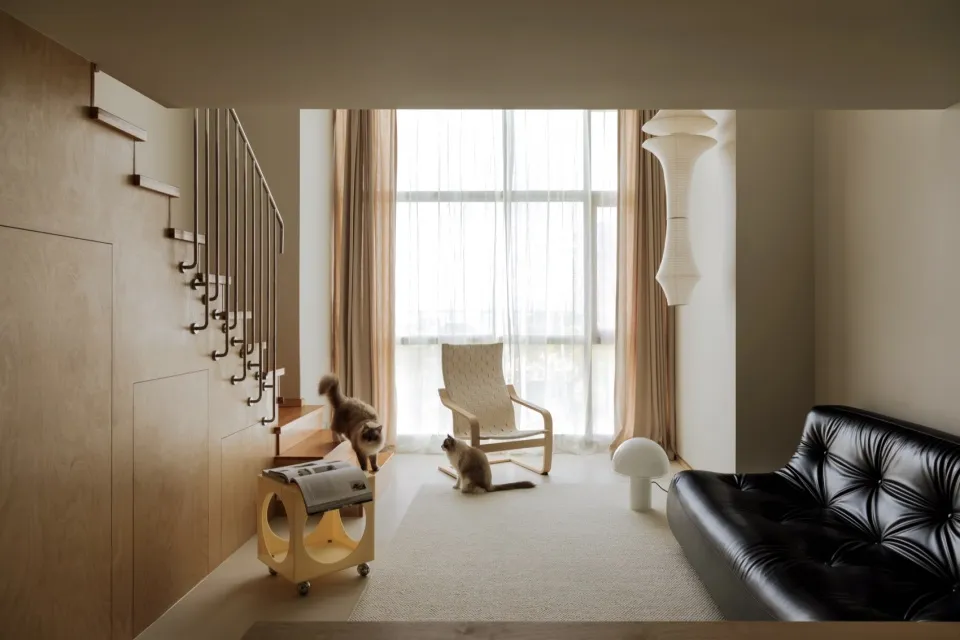 A modern living room featuring wood, glass, leather, and fabric.