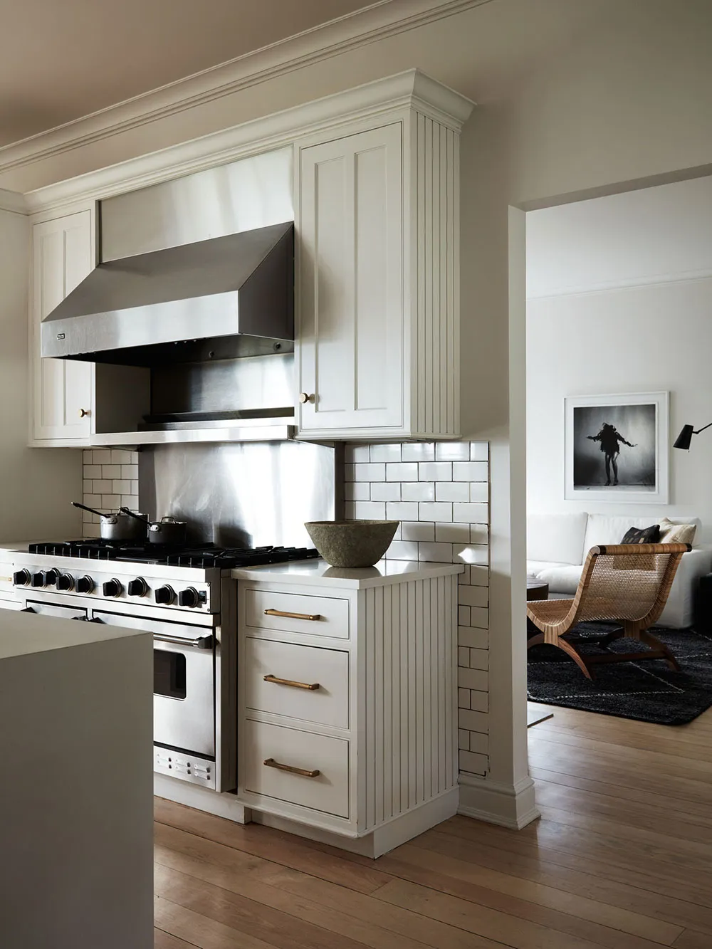 Modern kitchen featuring white cabinets, stainless steel appliances, and a clean, minimalistic design.