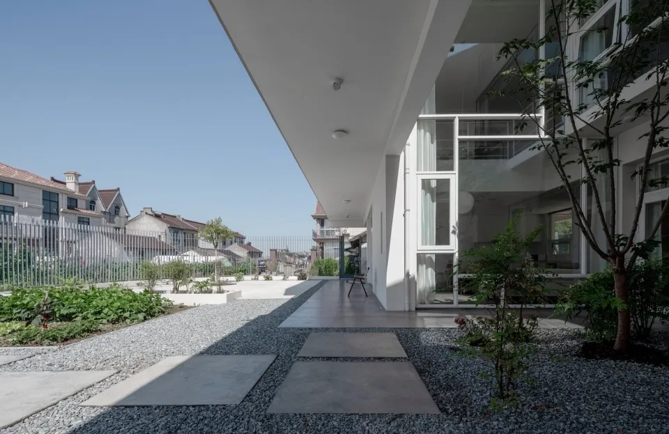 A modern residential entrance featuring concrete flooring and minimalist design.