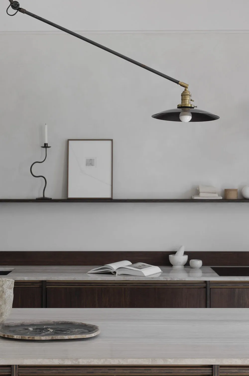 A minimalist kitchen featuring marble countertops and wooden cabinets.