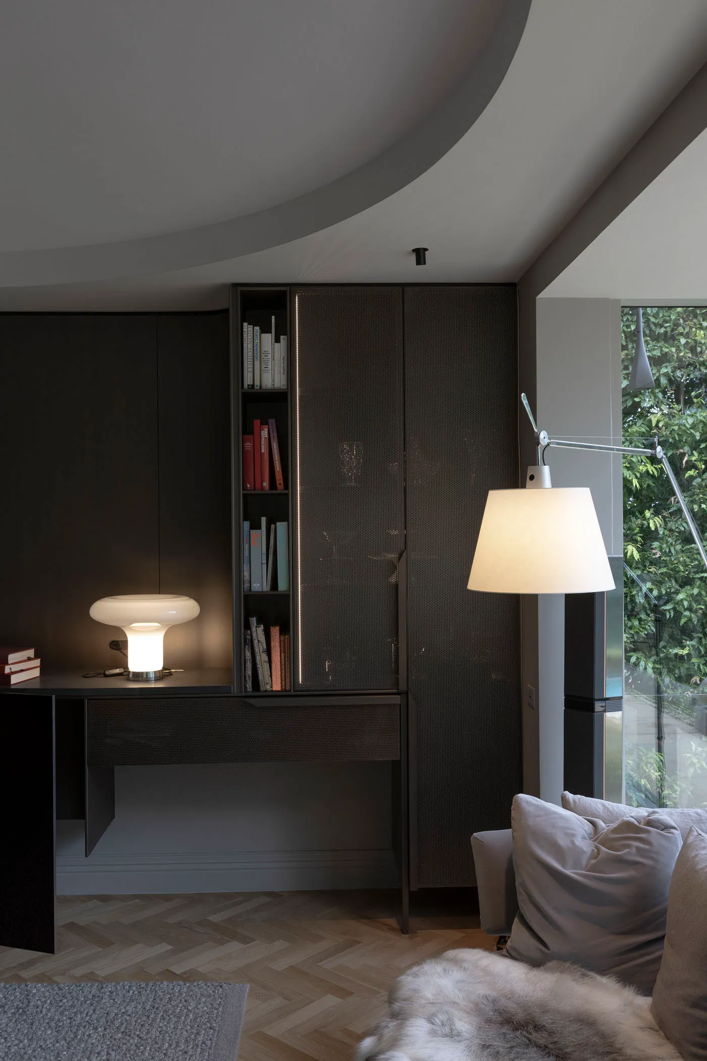 A modern living room featuring black furniture and a minimalist design.