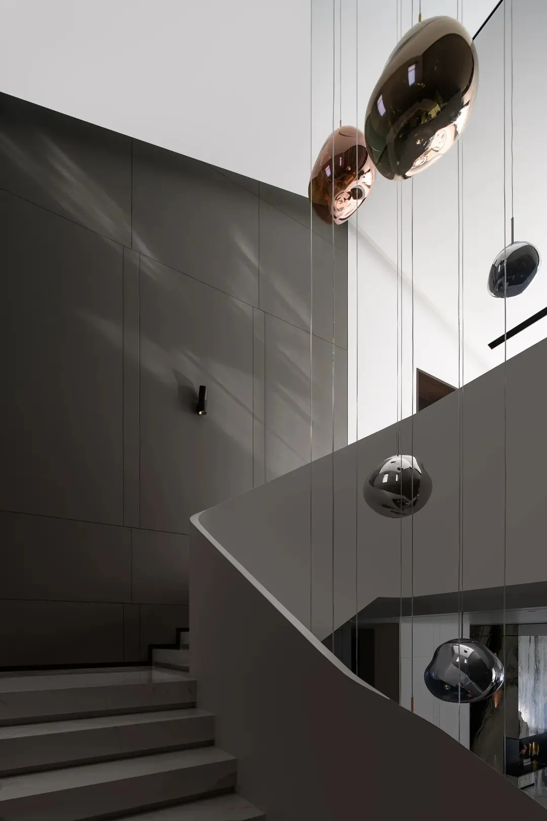 Modern staircase with metallic railing and wall lighting.