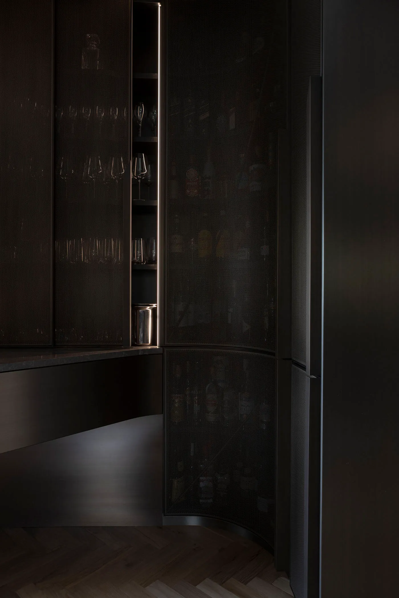 Modern interior design featuring a contemporary pantry cabinet with metal perforated panel.
