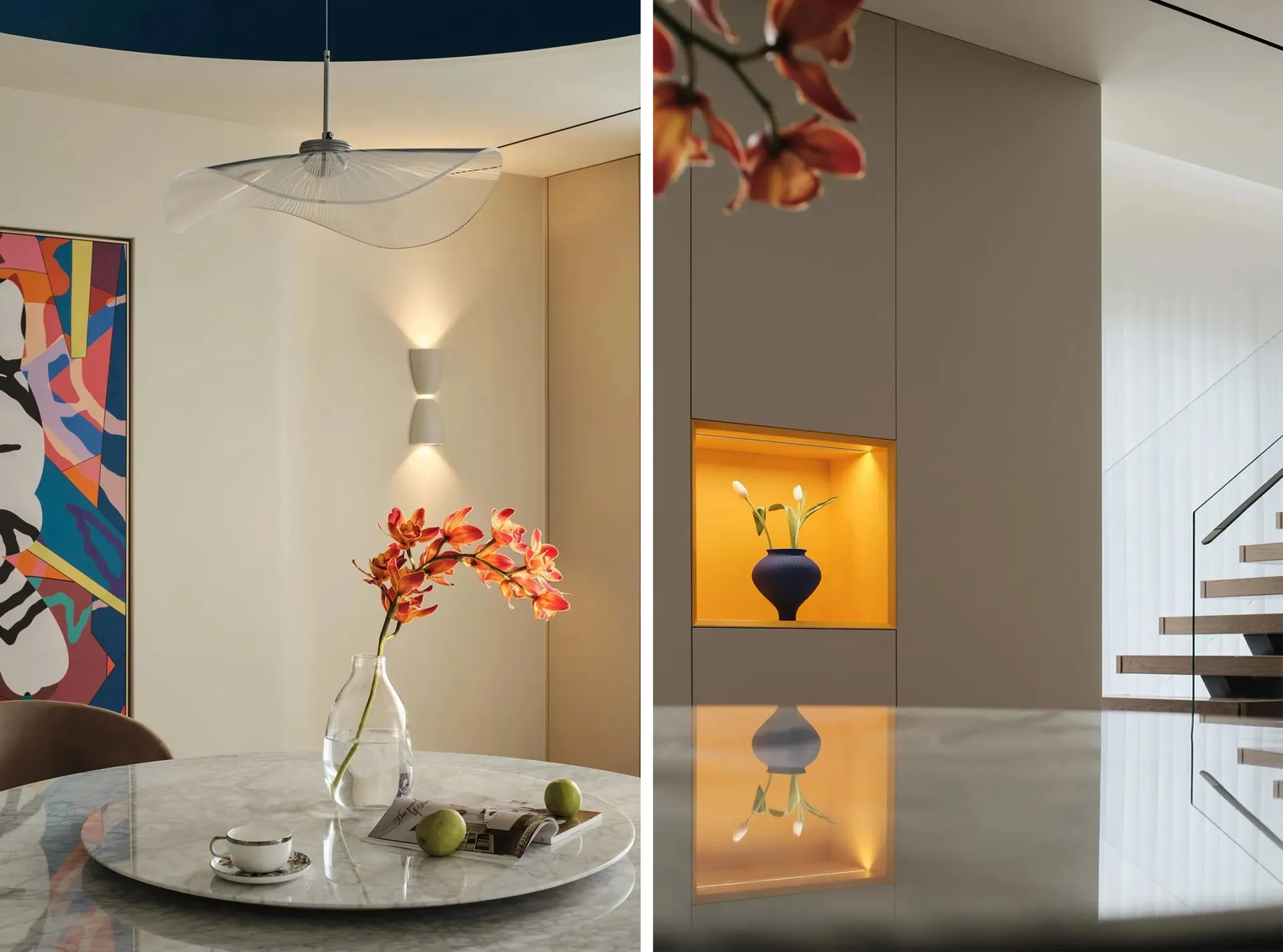 A modern dining room with a marble table and a round, white pendant light hanging above.