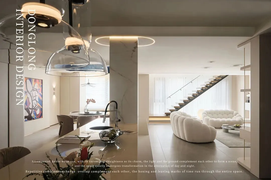 A modern living room featuring white marble surfaces and a cozy seating area.