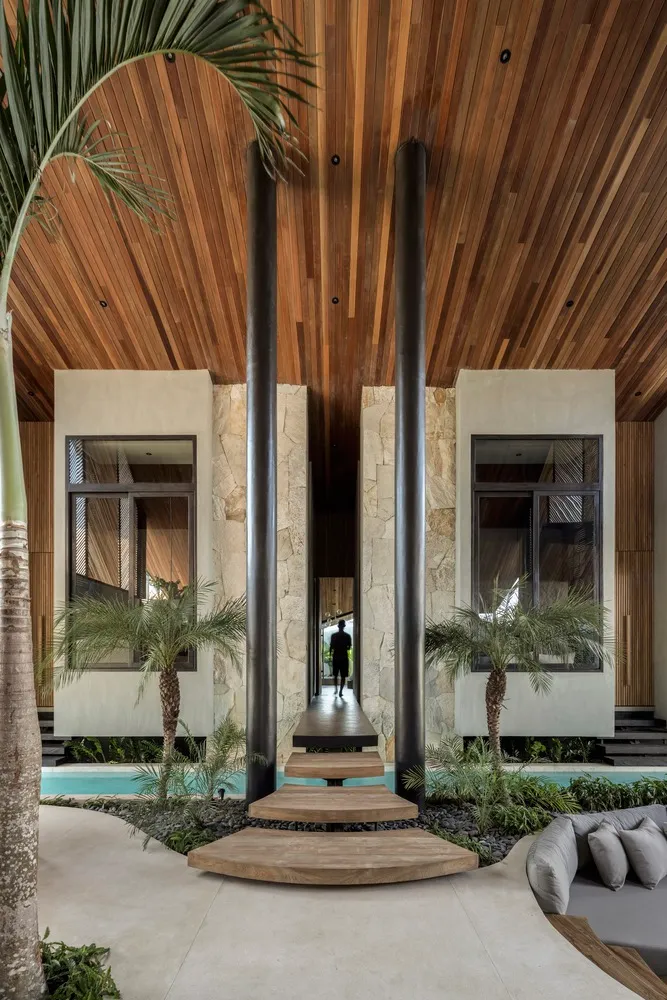 Modern minimalist residential entryway featuring wood and stone materials
