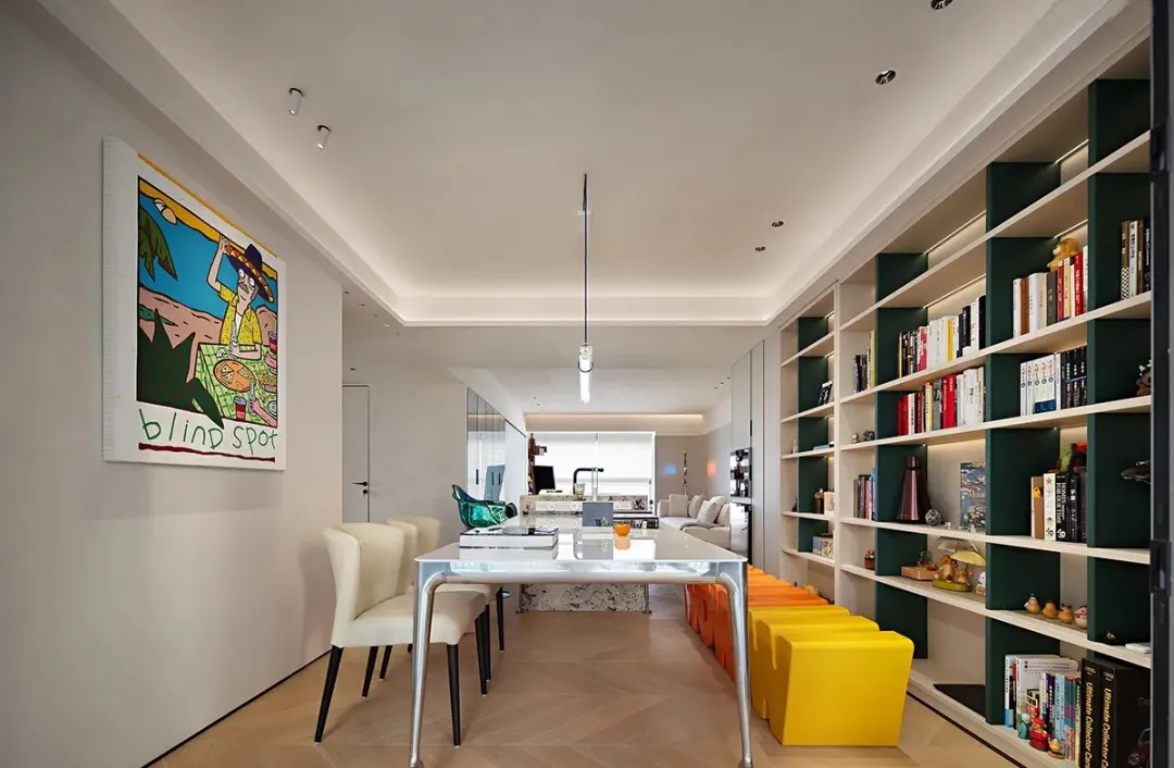 Modern interior design featuring a living room and library area with contemporary furniture, open shelving, and a hanging pen