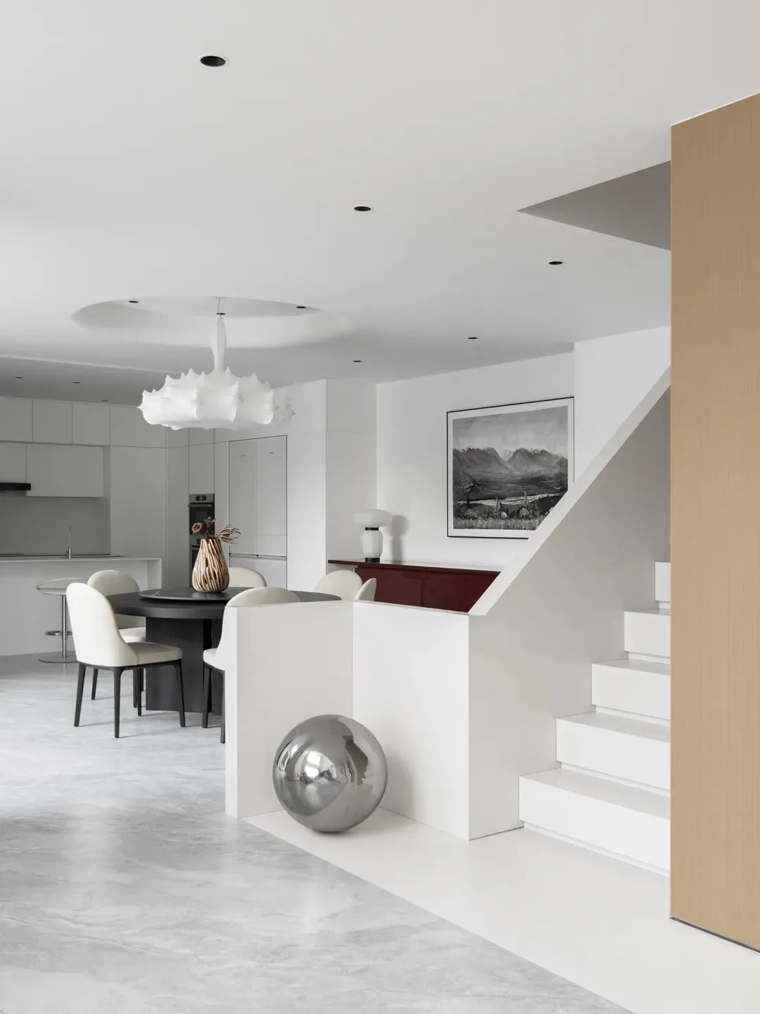 A minimalist residential interior with white marble and white lacquer finishes