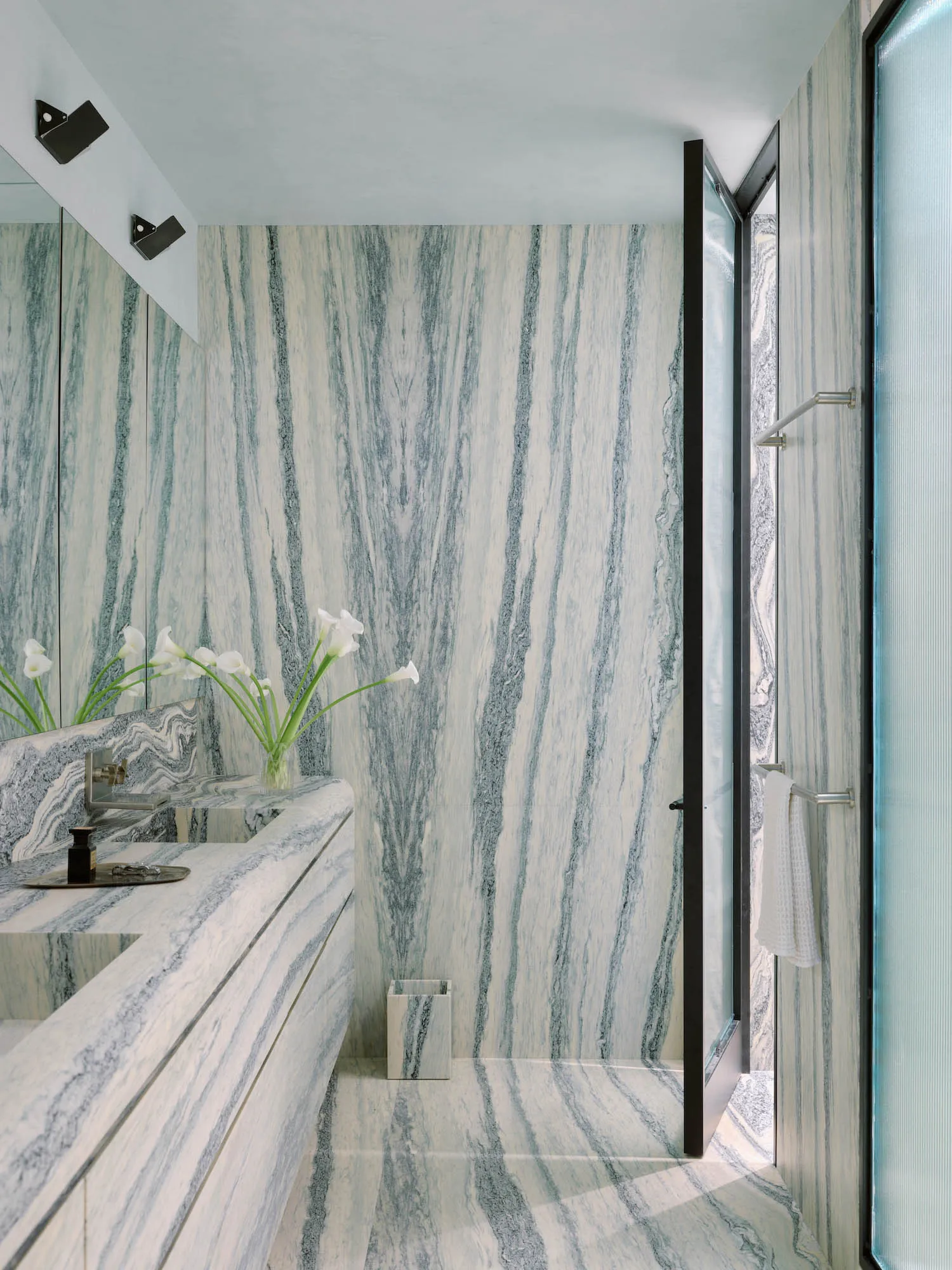 Modern bathroom with marble walls and floor, clean and clutter-free design.