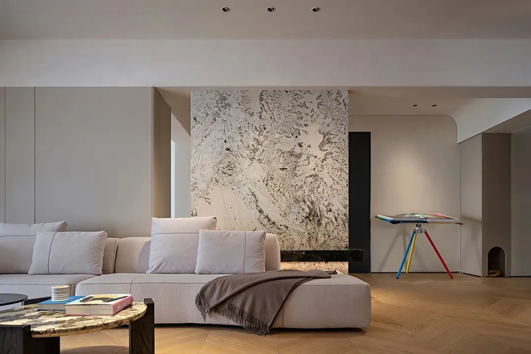 A modern minimalist living room featuring marble and wooden elements.