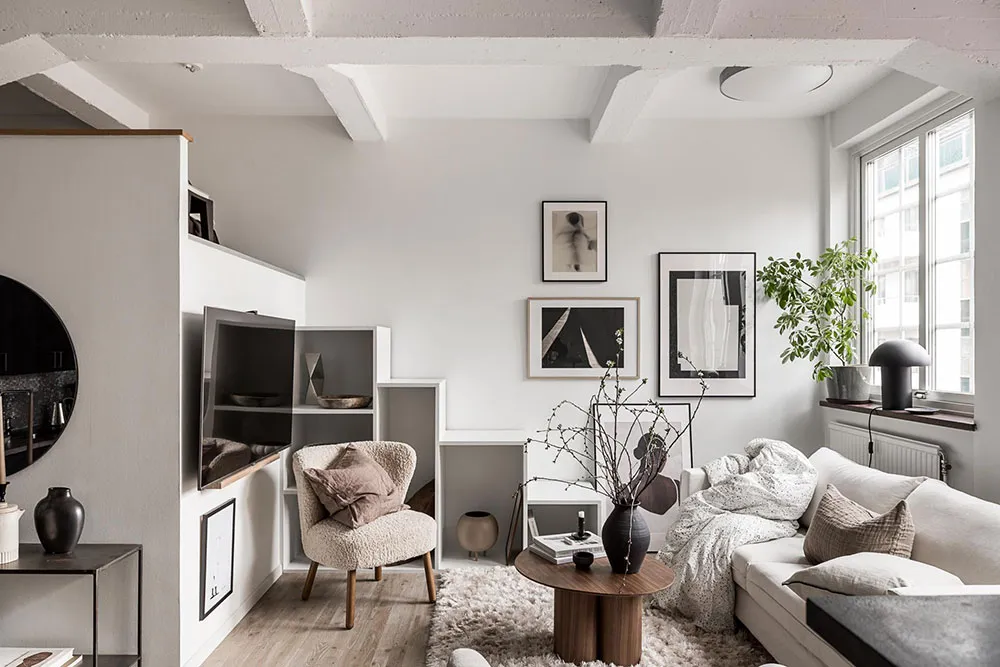 A minimalist living room with neutral-toned furniture and decor.