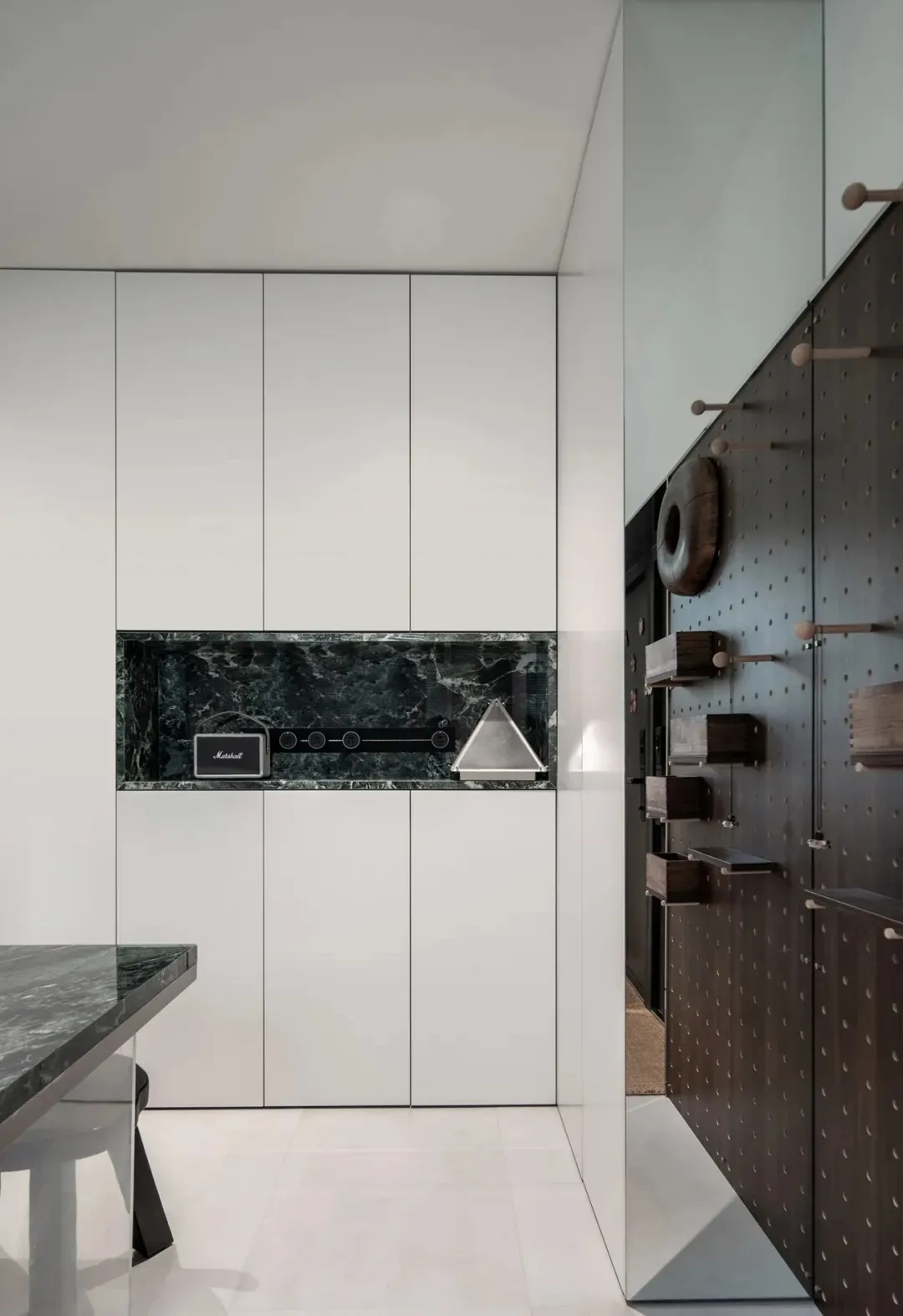 An industrial-style storage unit featuring metal finishes and a marble countertop.