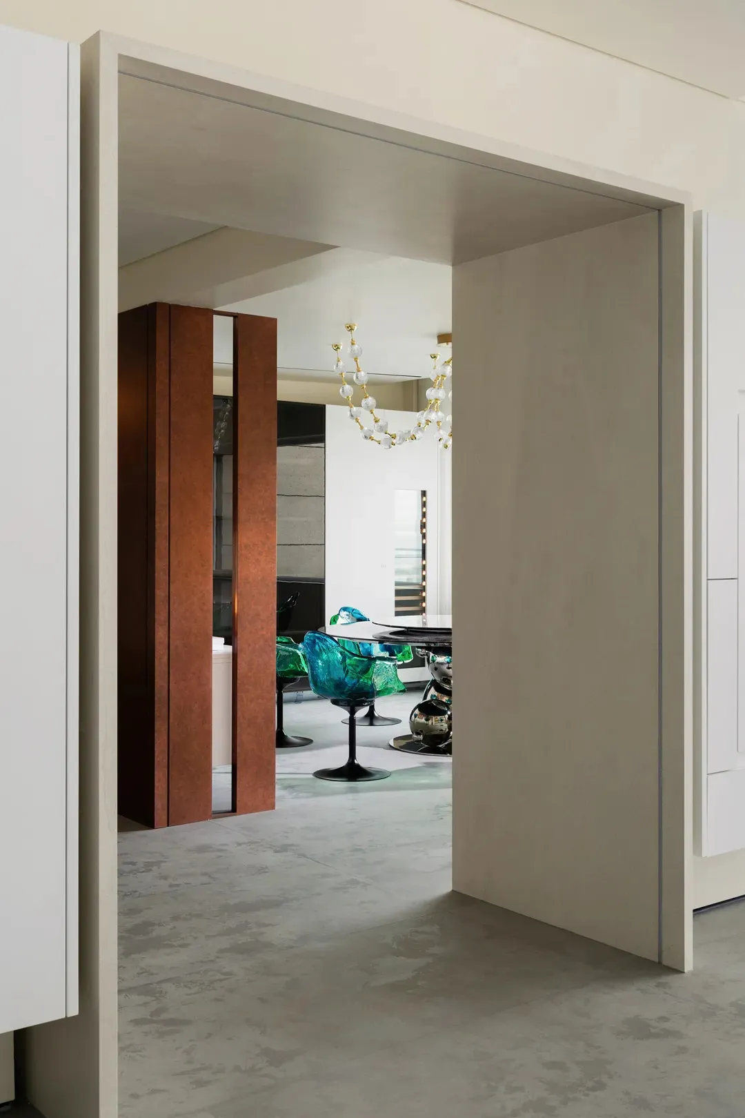 A modern vertical office space with a large glass wall and metal panels.