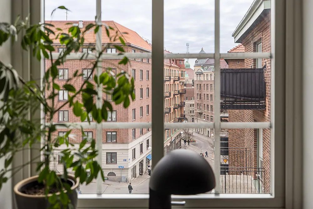 Window view of a residential area with red brick buildings.