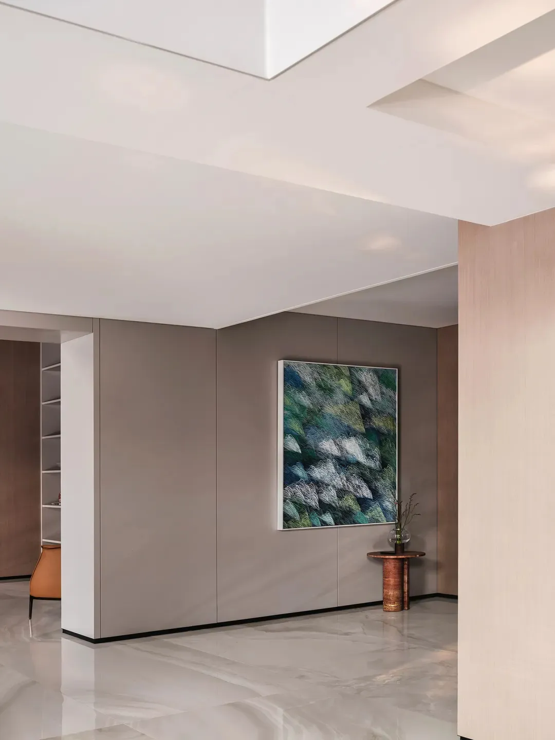 Modern minimalist living room with concrete flooring, wall art, and minimalist furniture.