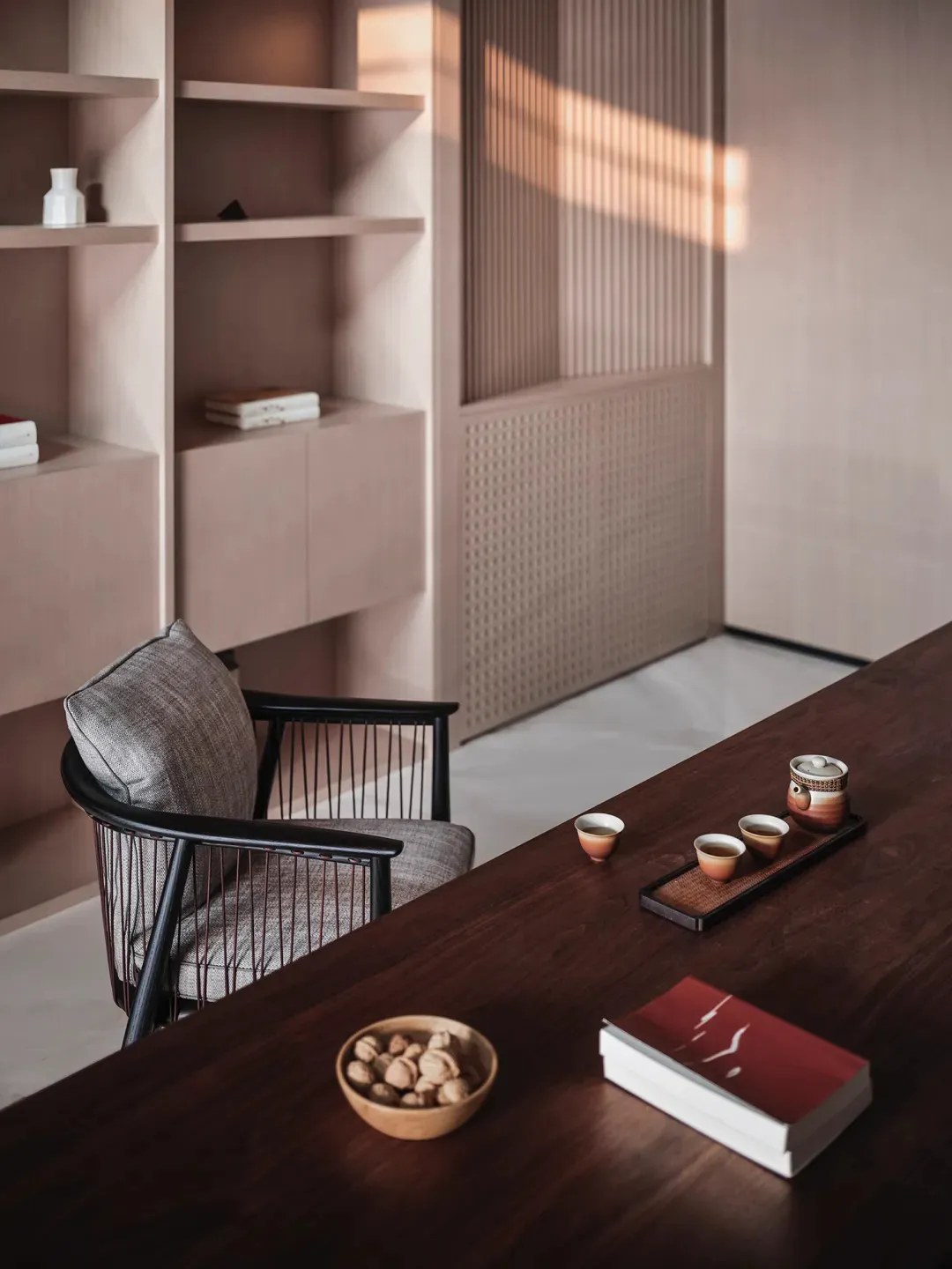 A modern office with a wooden desk, minimalist design, and a chair.
