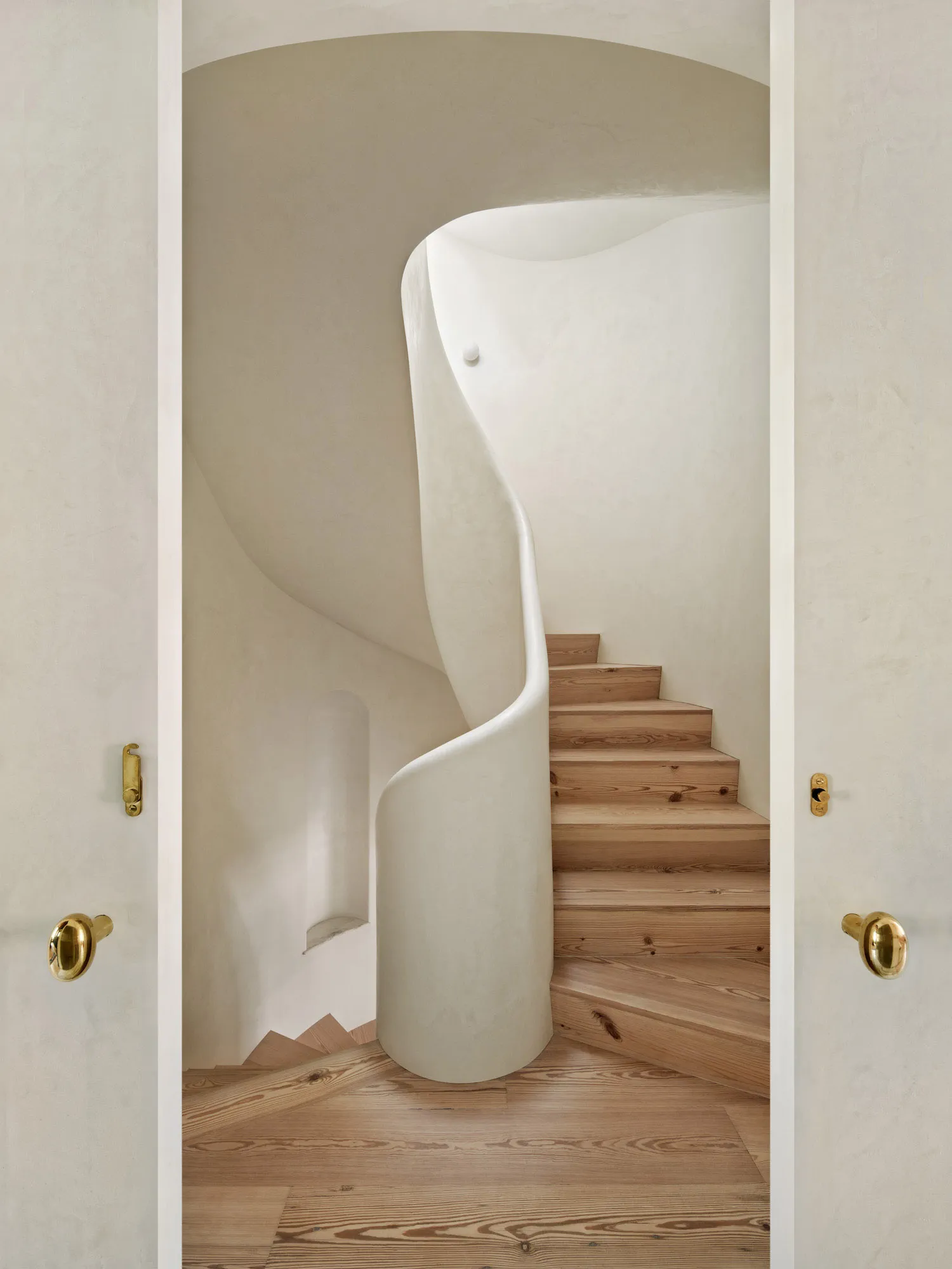A modern staircase featuring a combination of concrete and wooden elements.