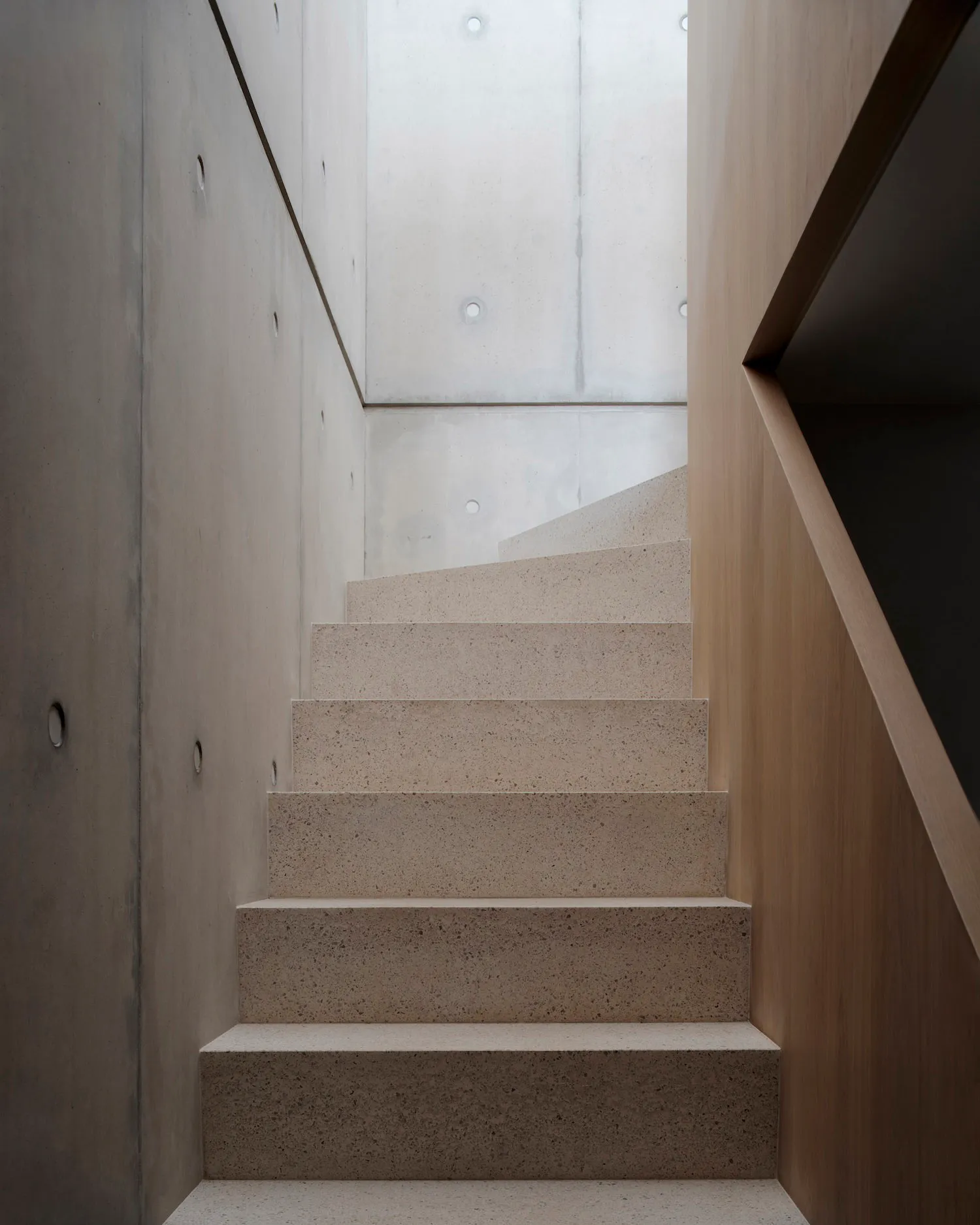 A modern minimalist staircase made of concrete.
