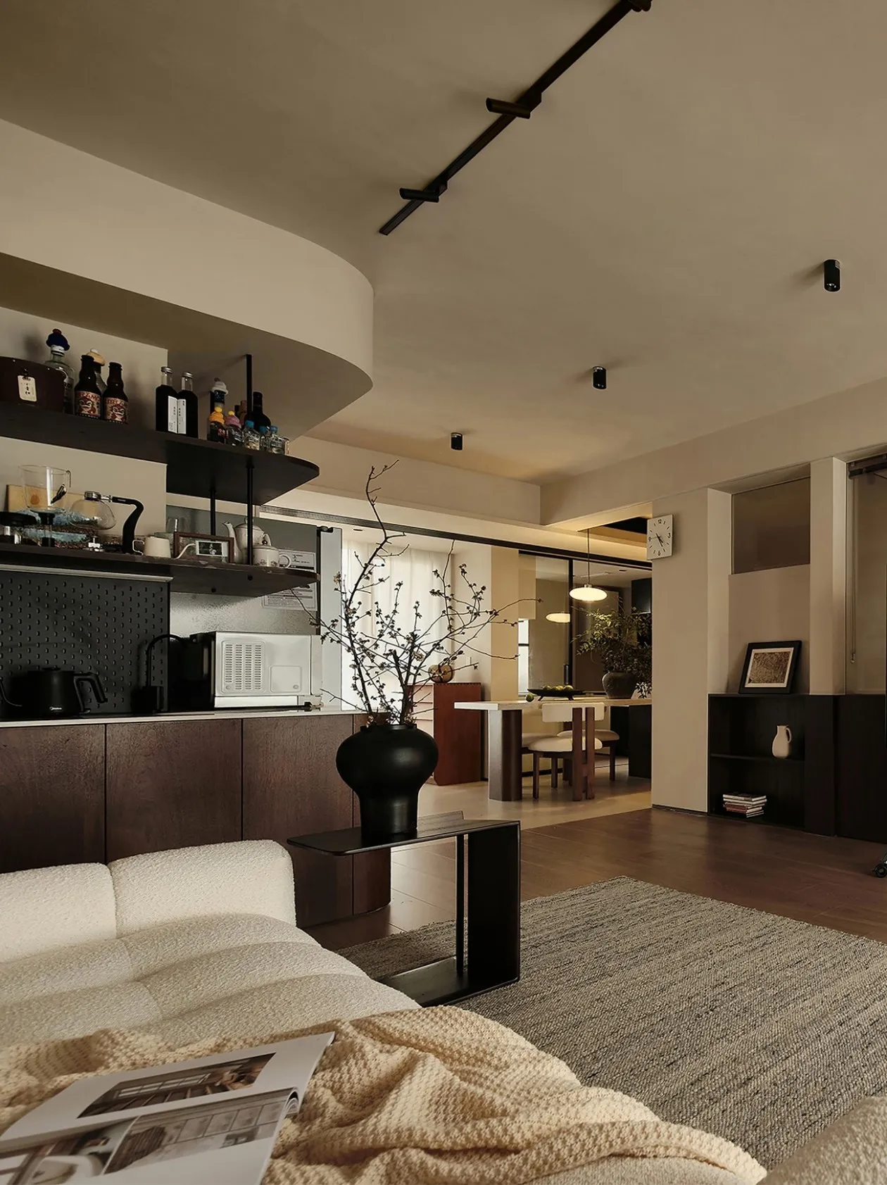 A minimalist living room with neutral-colored furniture and decor.