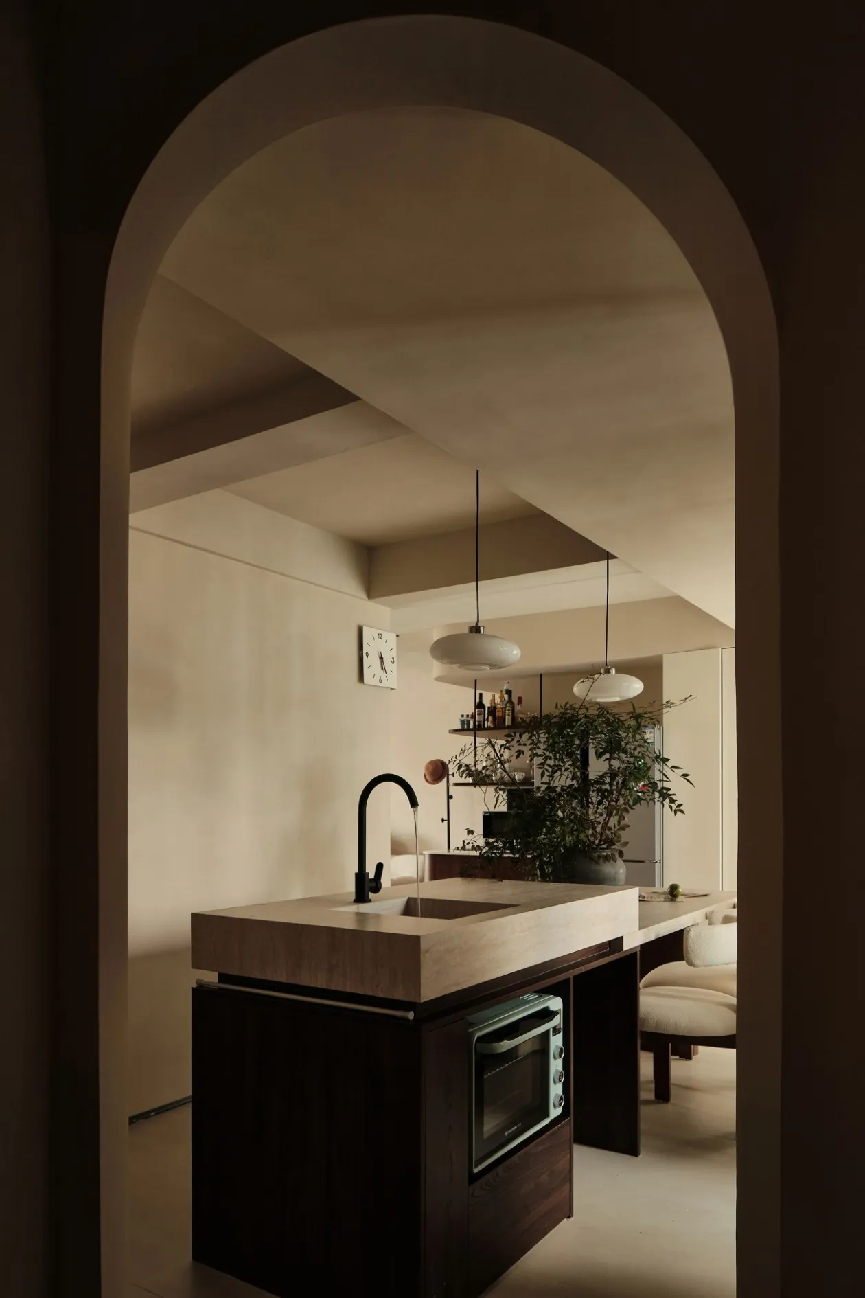 Modern kitchen with concrete countertops and black faucet.