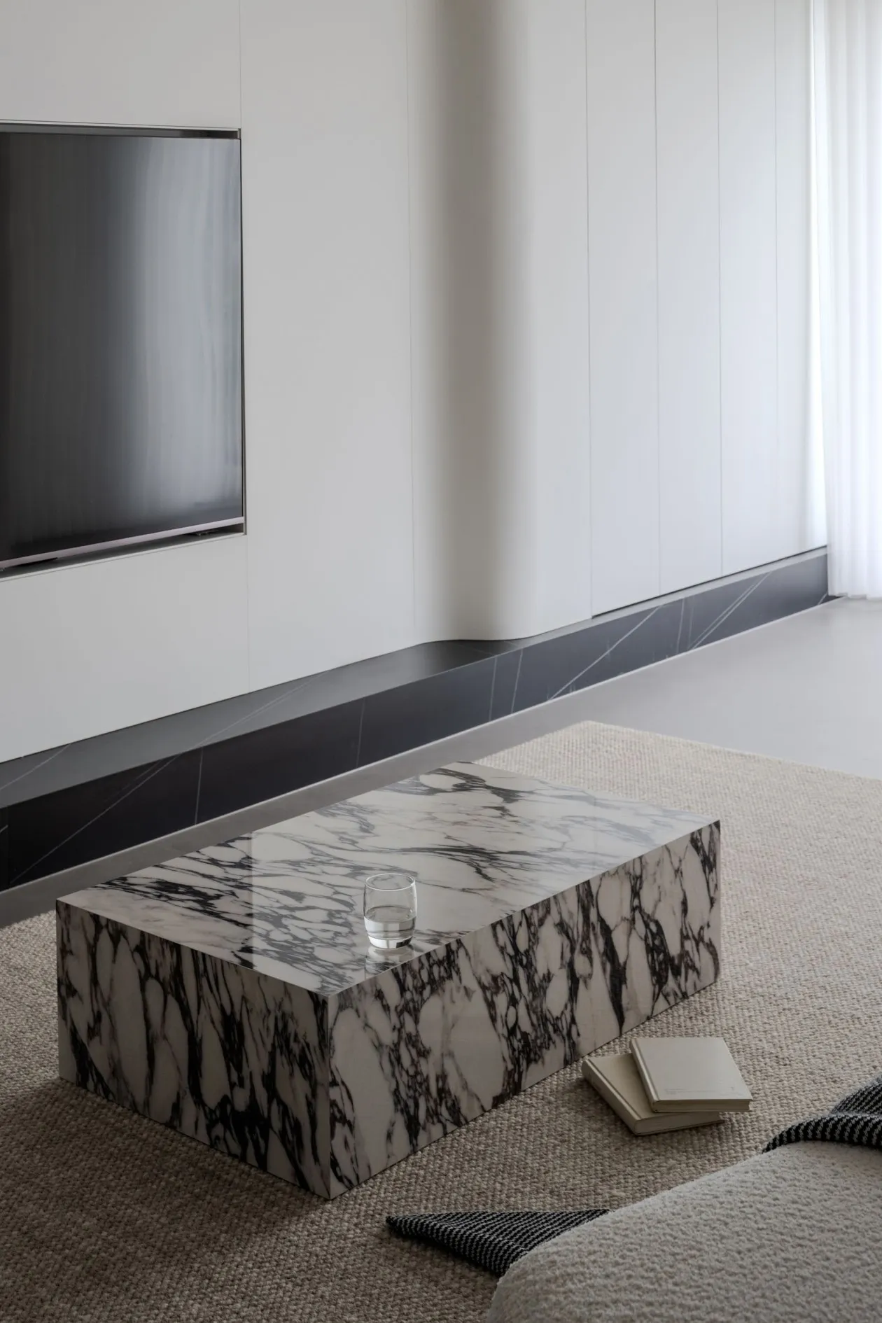 Modern living room featuring a rectangular marble coffee table with a minimalist design.