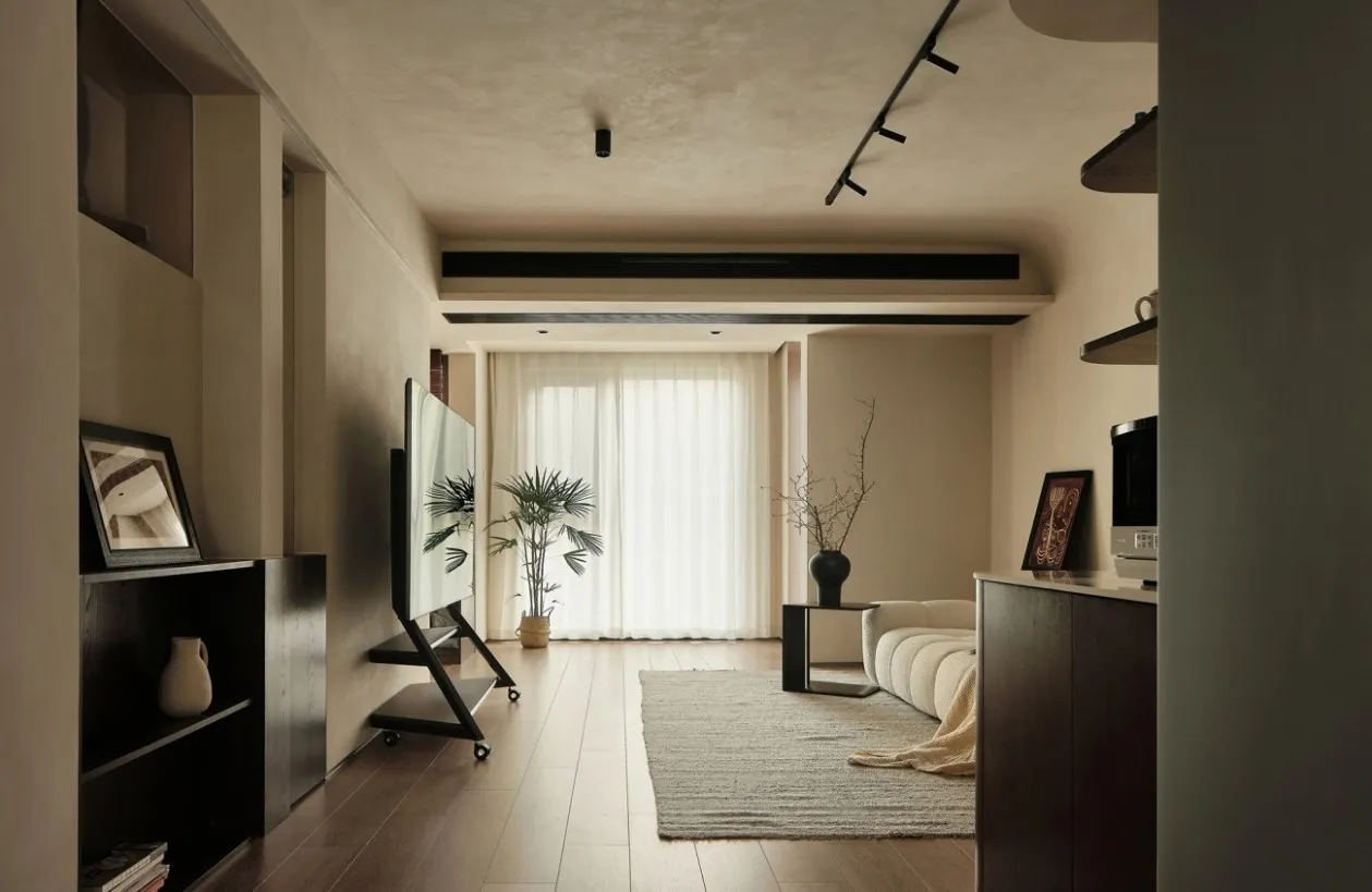 A minimalist residential space featuring wooden elements and a large window.