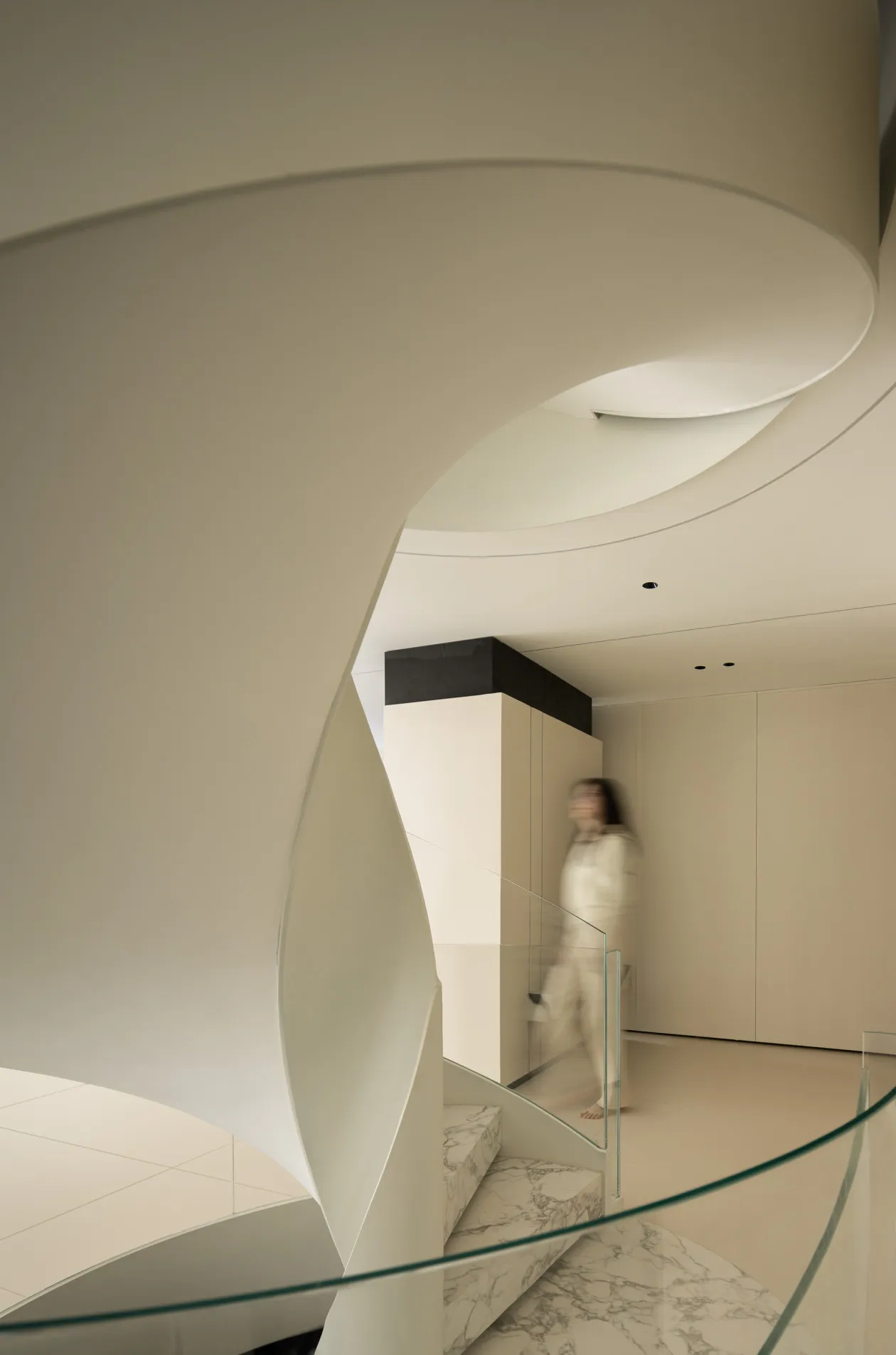 A modern interior space featuring glass and marble elements.