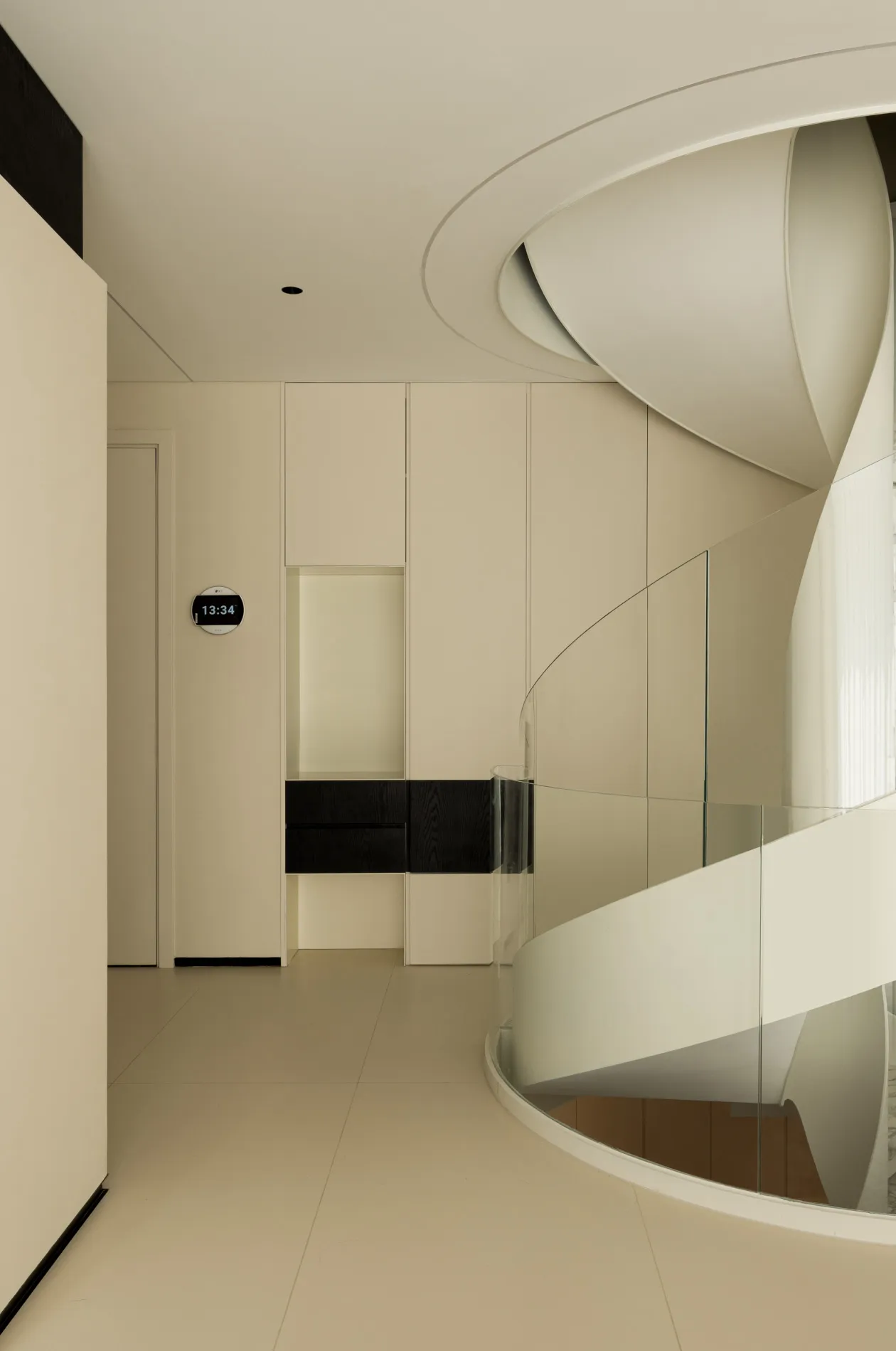 Modern interior design featuring a glass spiral staircase.