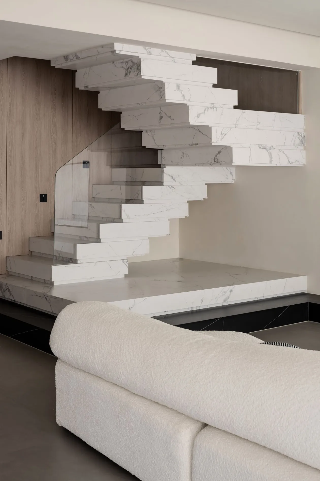 Modern interior design featuring a contemporary marble staircase in a living room setting.