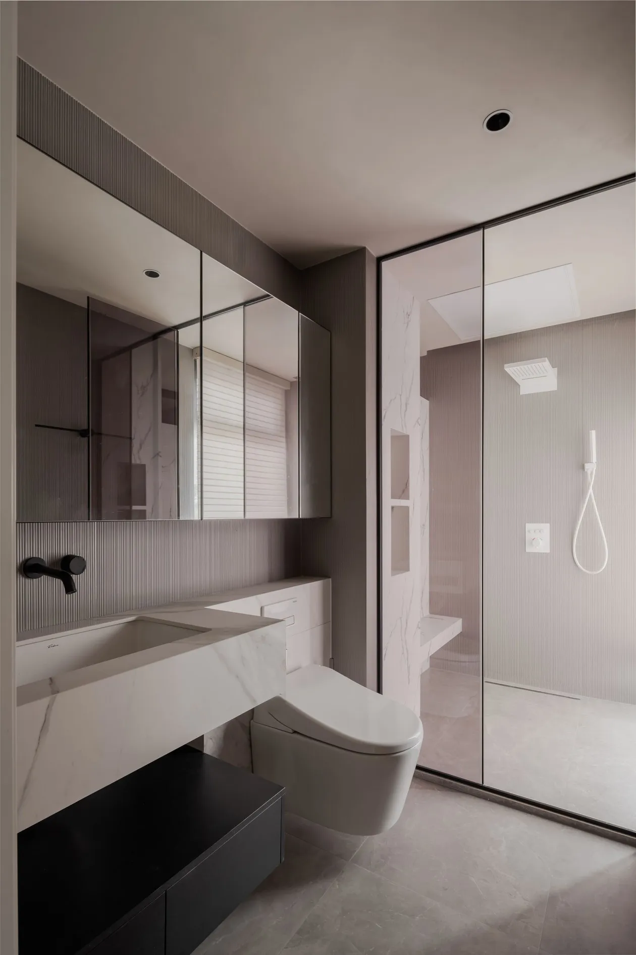 A modern minimalist bathroom featuring marble finishes and contemporary design elements.