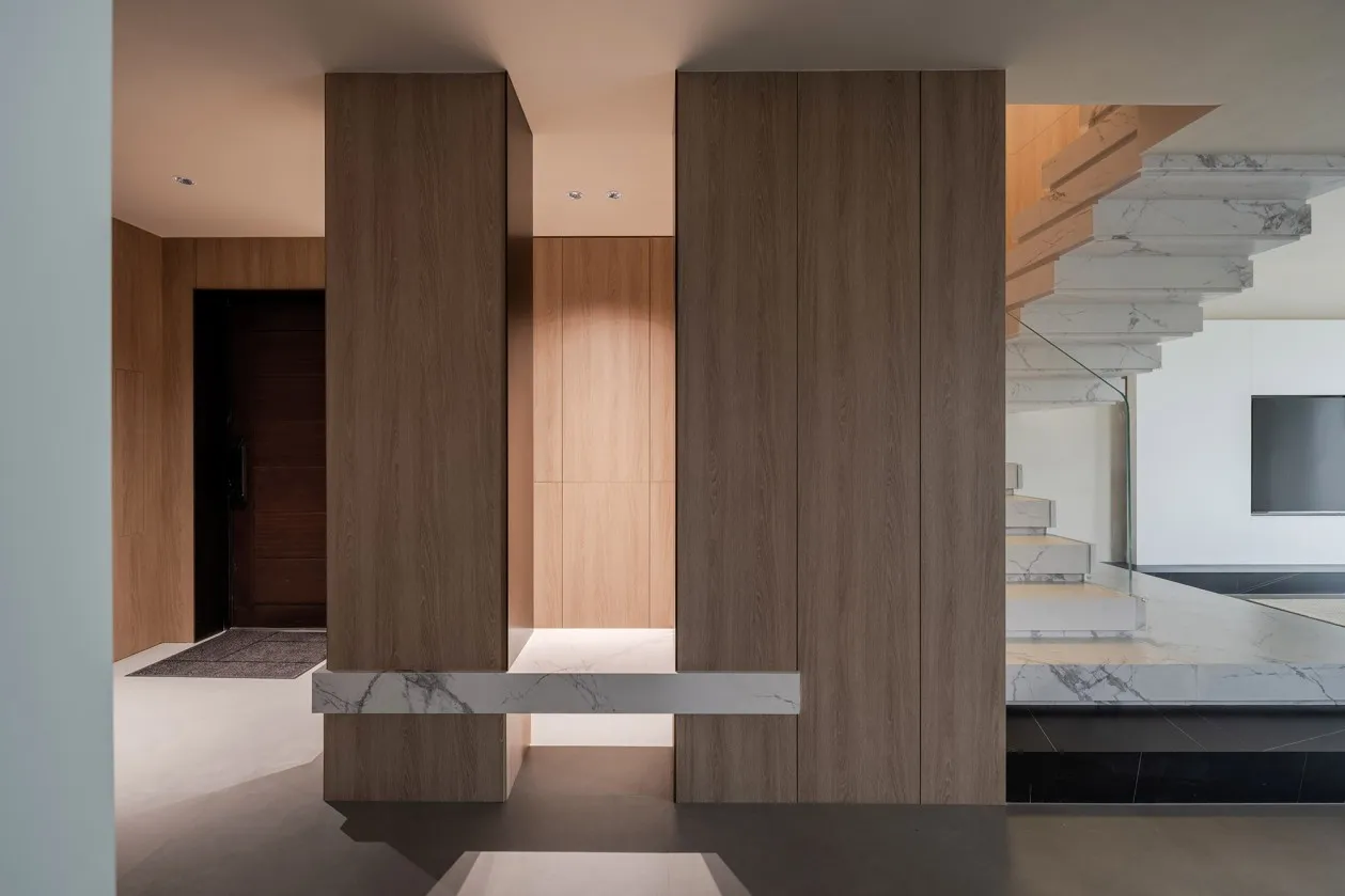 Modern residential lobby featuring wood and marble materials.